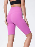 High-rise active shorts with wide waistband, bright pink, knee-length, back view