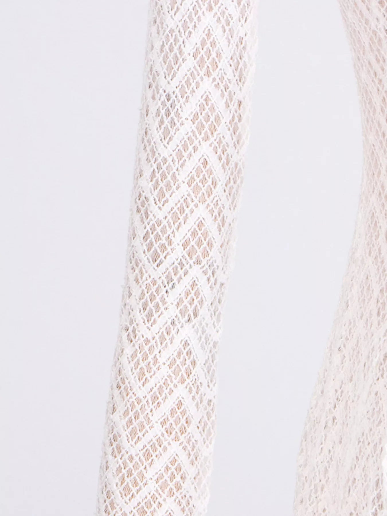 White lace long-sleeve fabric close-up with diamond trellis pattern