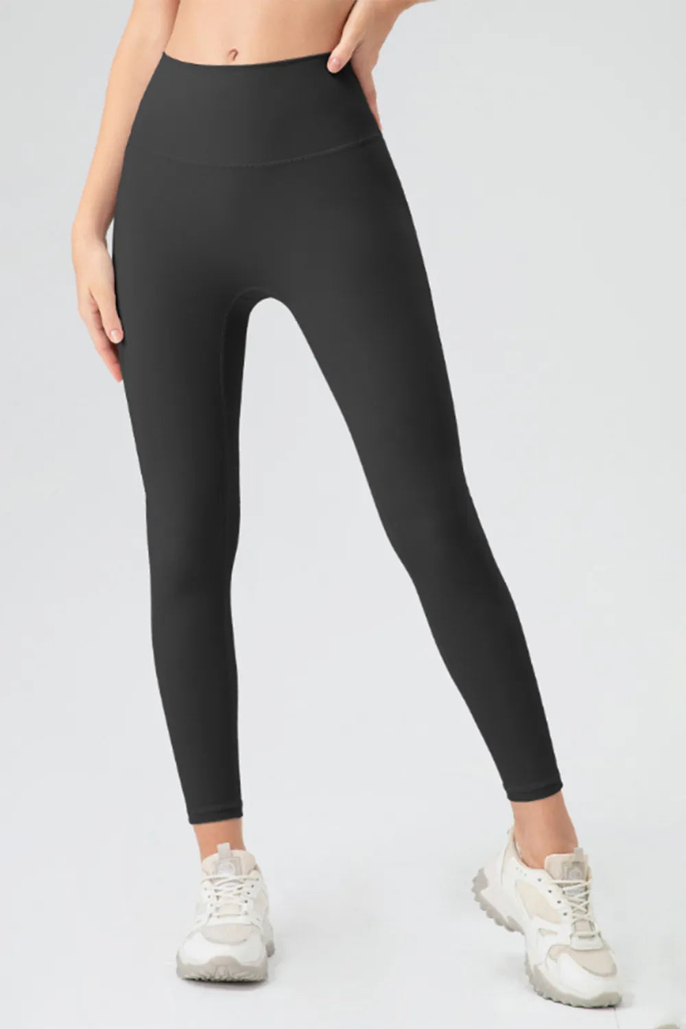 High-waist skinny active pants, black, front view with fitted legs and ankle length