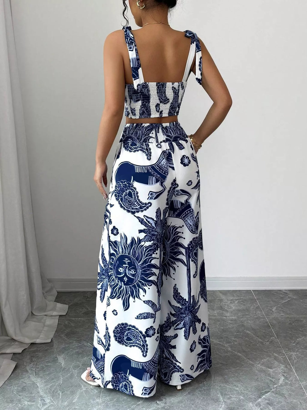 Blue and white floral sleeveless crop top and wide-leg pants set, back view