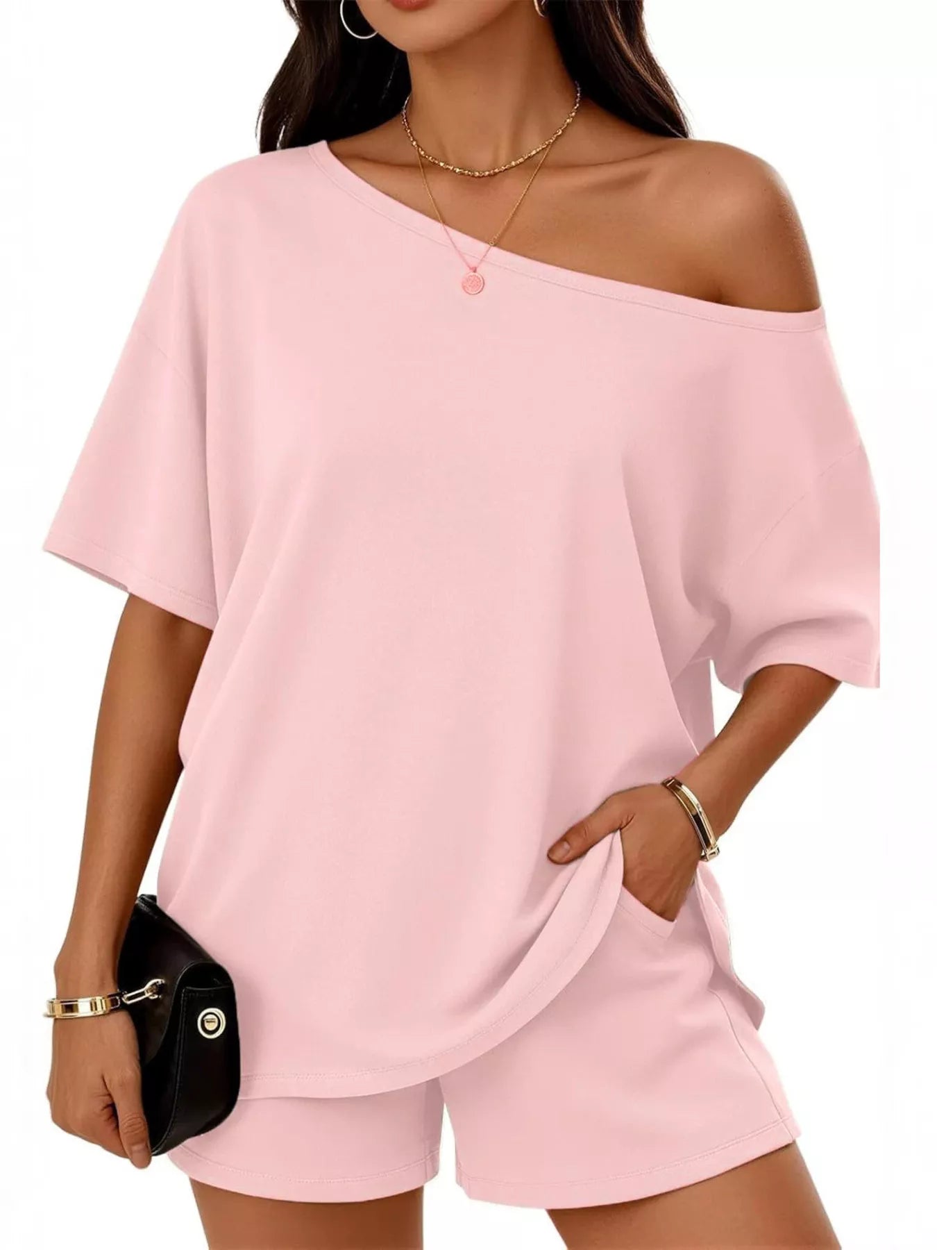 Soft pink one-shoulder top and matching shorts set, loose fit with short sleeves.