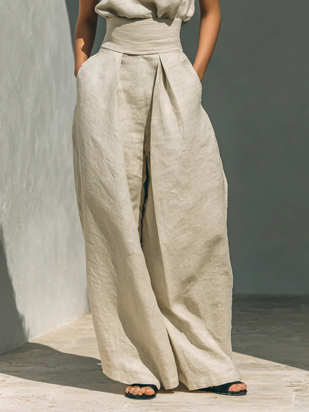 Ivory wide-leg pants with matching sleeveless turtleneck top, front full-length view