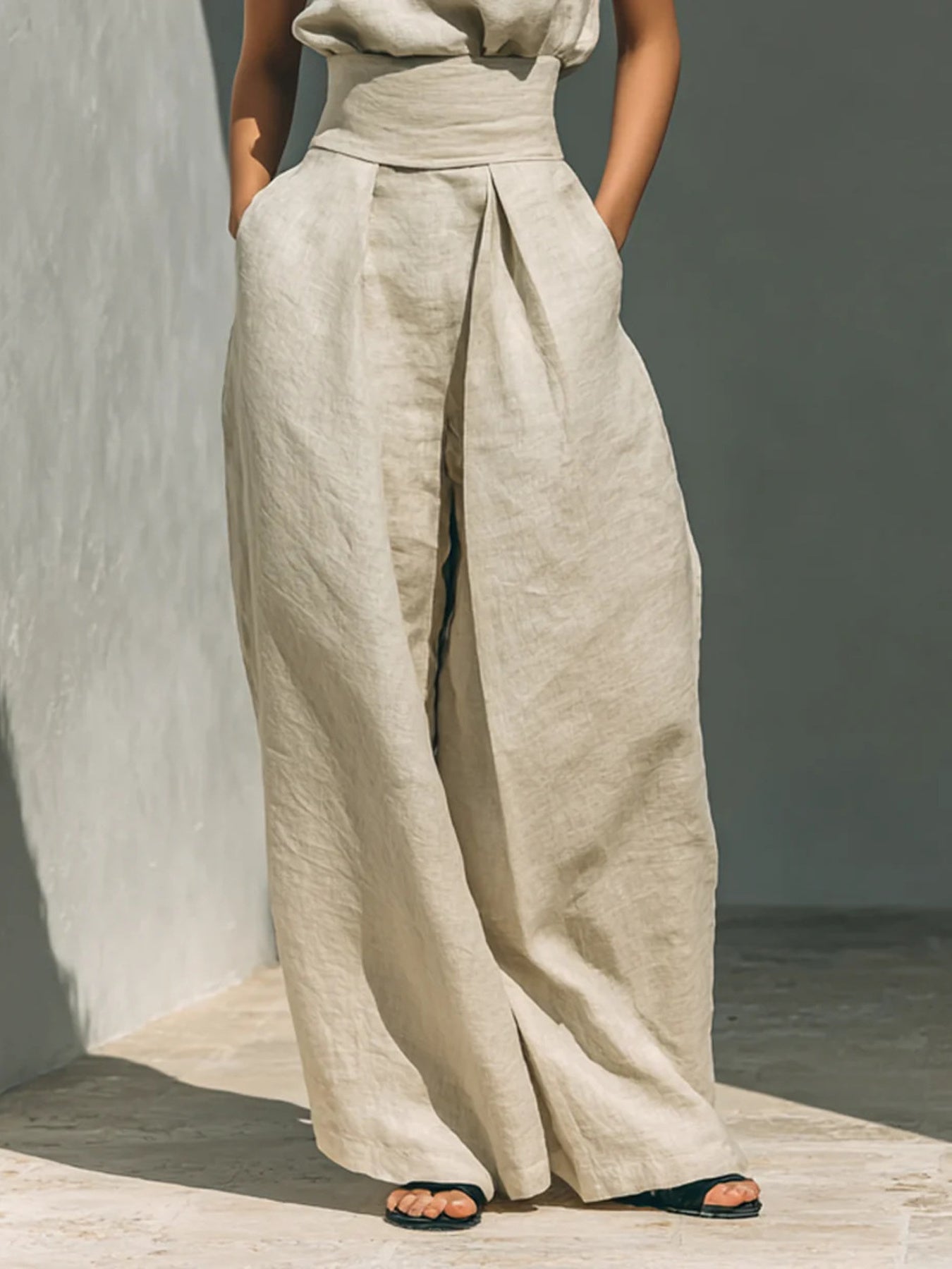 Ivory wide-leg pants with matching sleeveless turtleneck top, front full-length view
