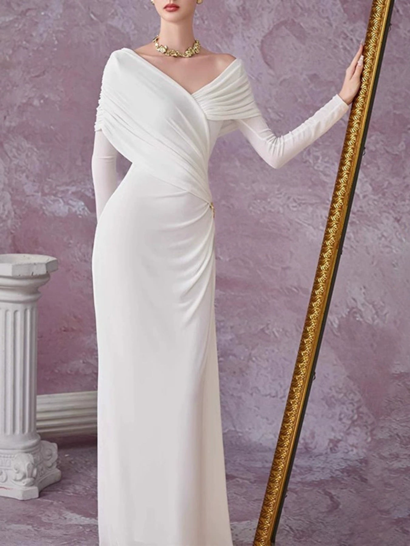 White draped ruched maxi dress with V-neck, long sleeves, and twisted shoulder neckline.