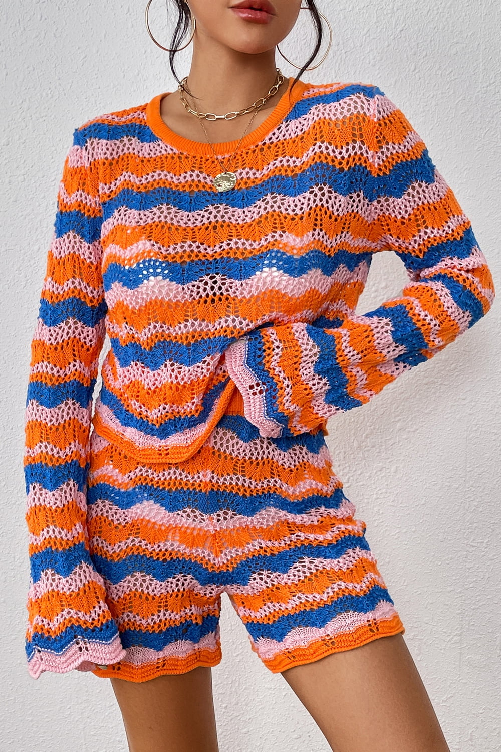 Striped knit sweater and shorts set in orange-red and blue wavy stripes, long sleeves.