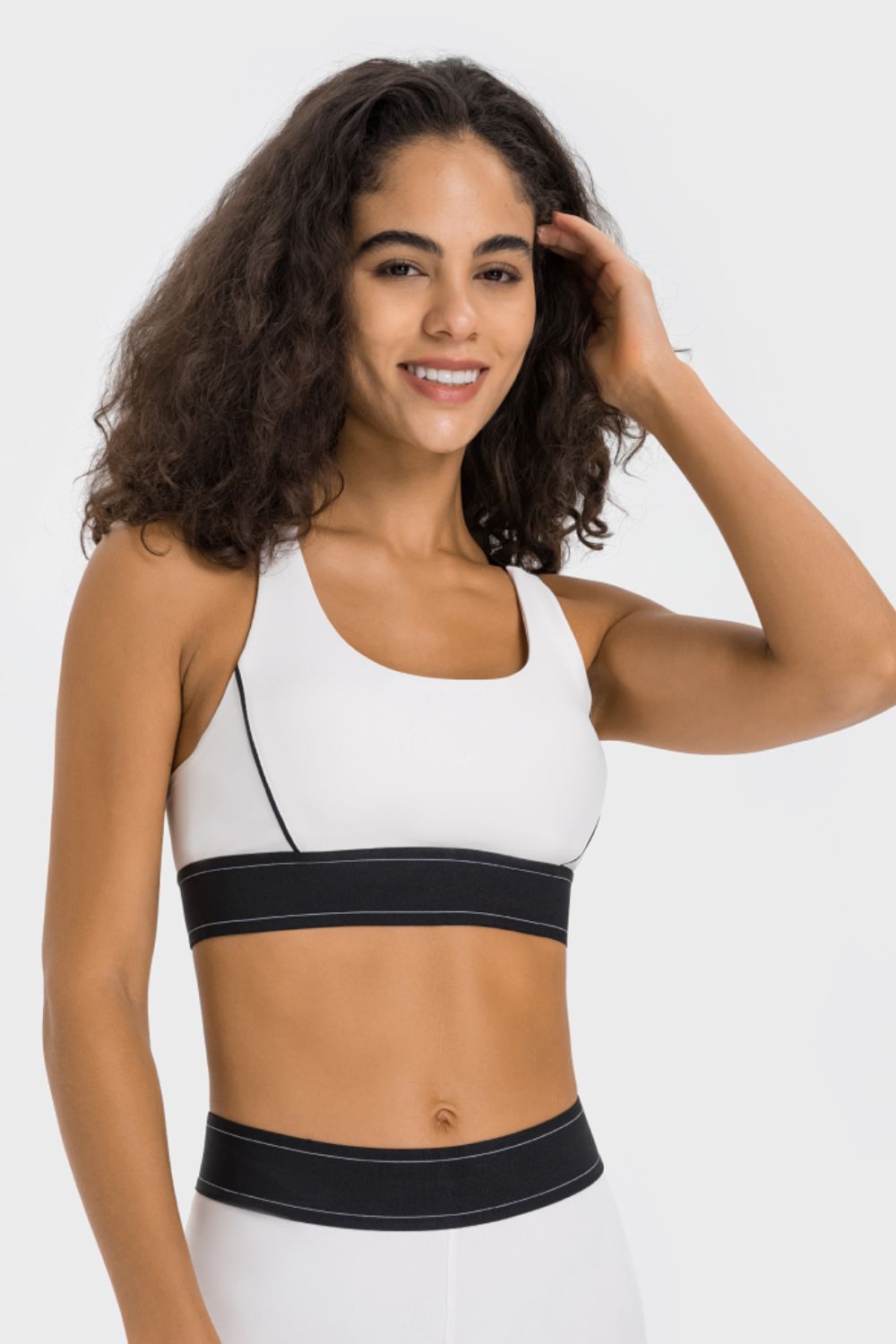 White contrast sports bra with black trim and racerback strap