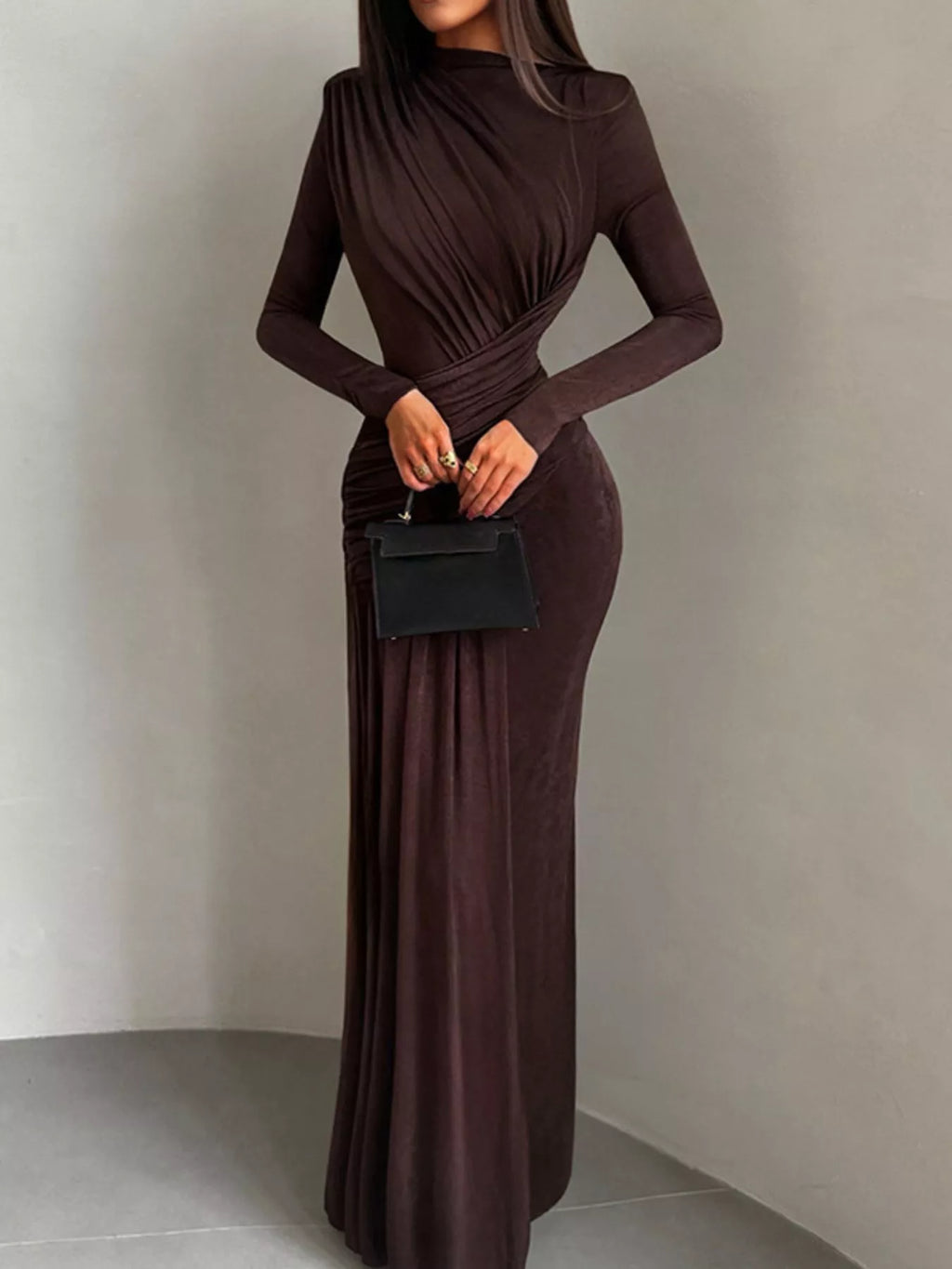 Brown long-sleeve maxi dress with high neck and ruched bodice, draped at the waist
