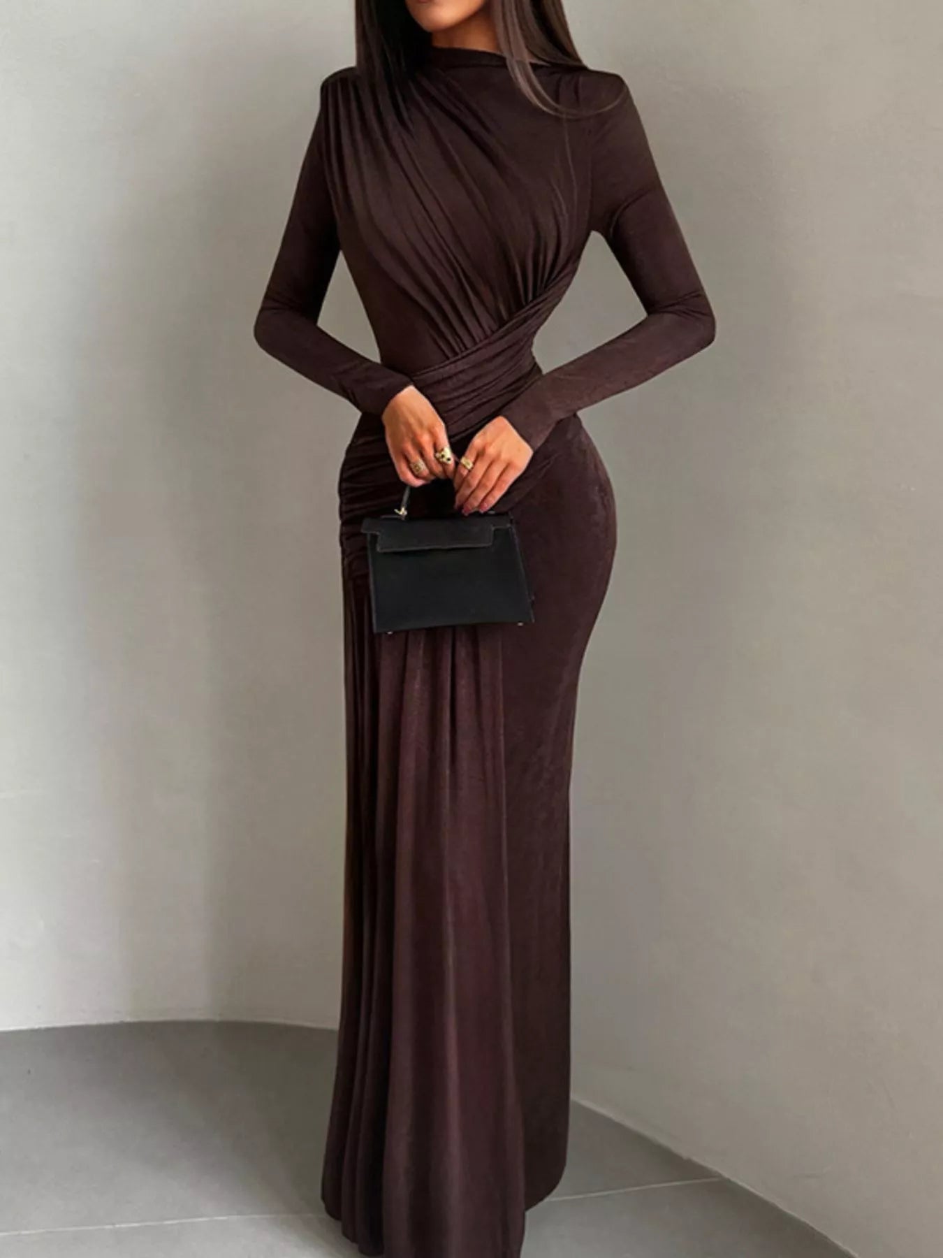 Brown long-sleeve maxi dress with high neck and ruched bodice, draped at the waist