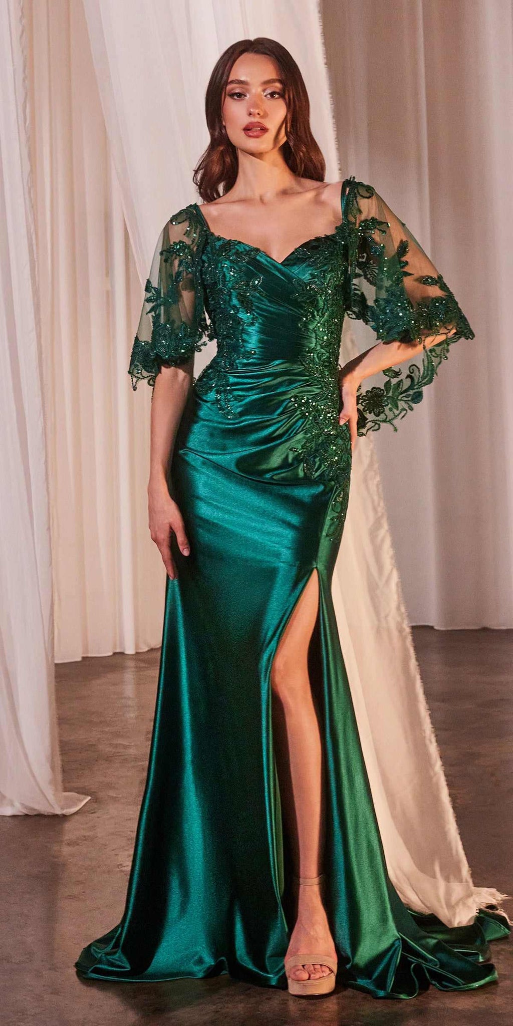 Emerald green stretch satin fitted evening dress with lace caplet sleeves and slit