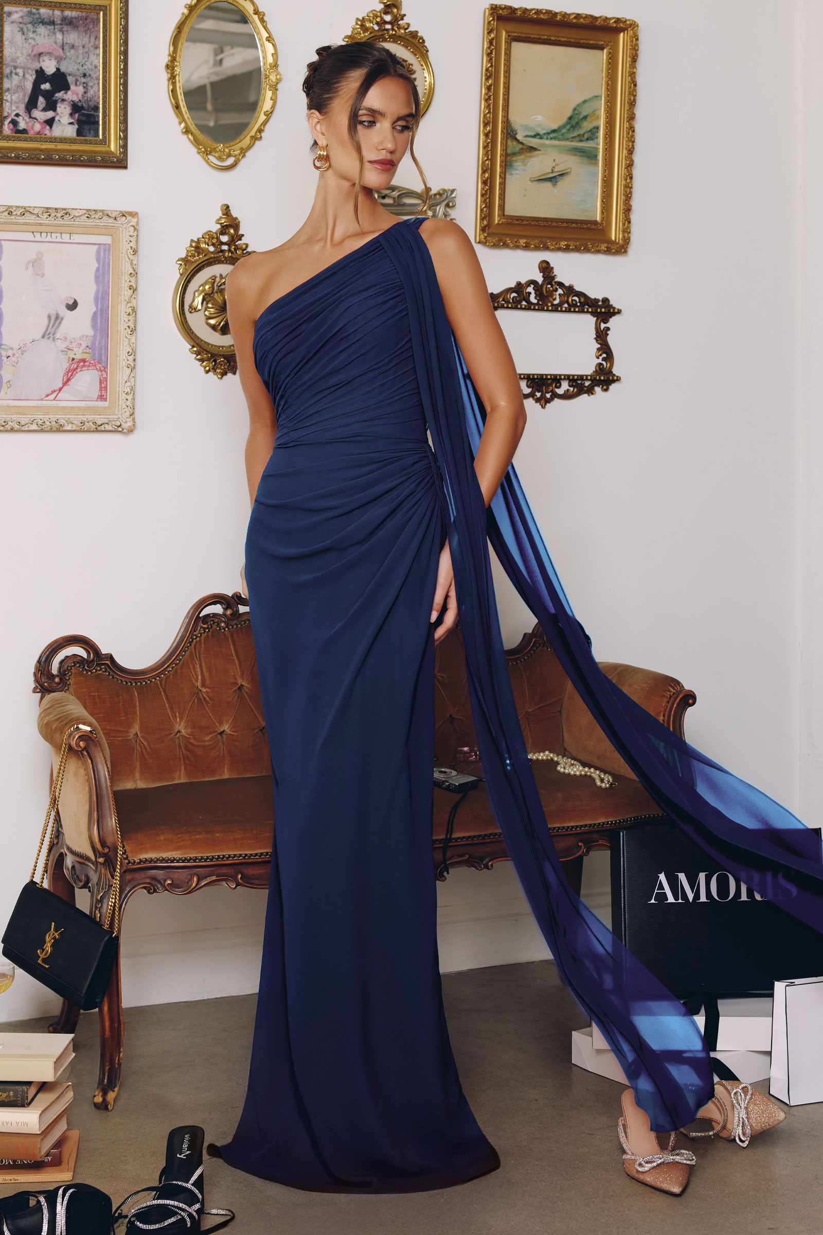Navy blue one-shoulder chiffon formal gown with draped side detail and flowing floor-length skirt