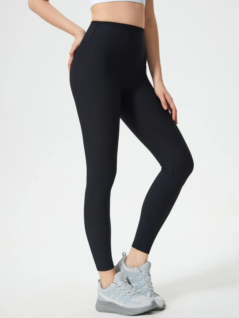 Black high-waist active leggings, full length tapered legs with ankle cuff