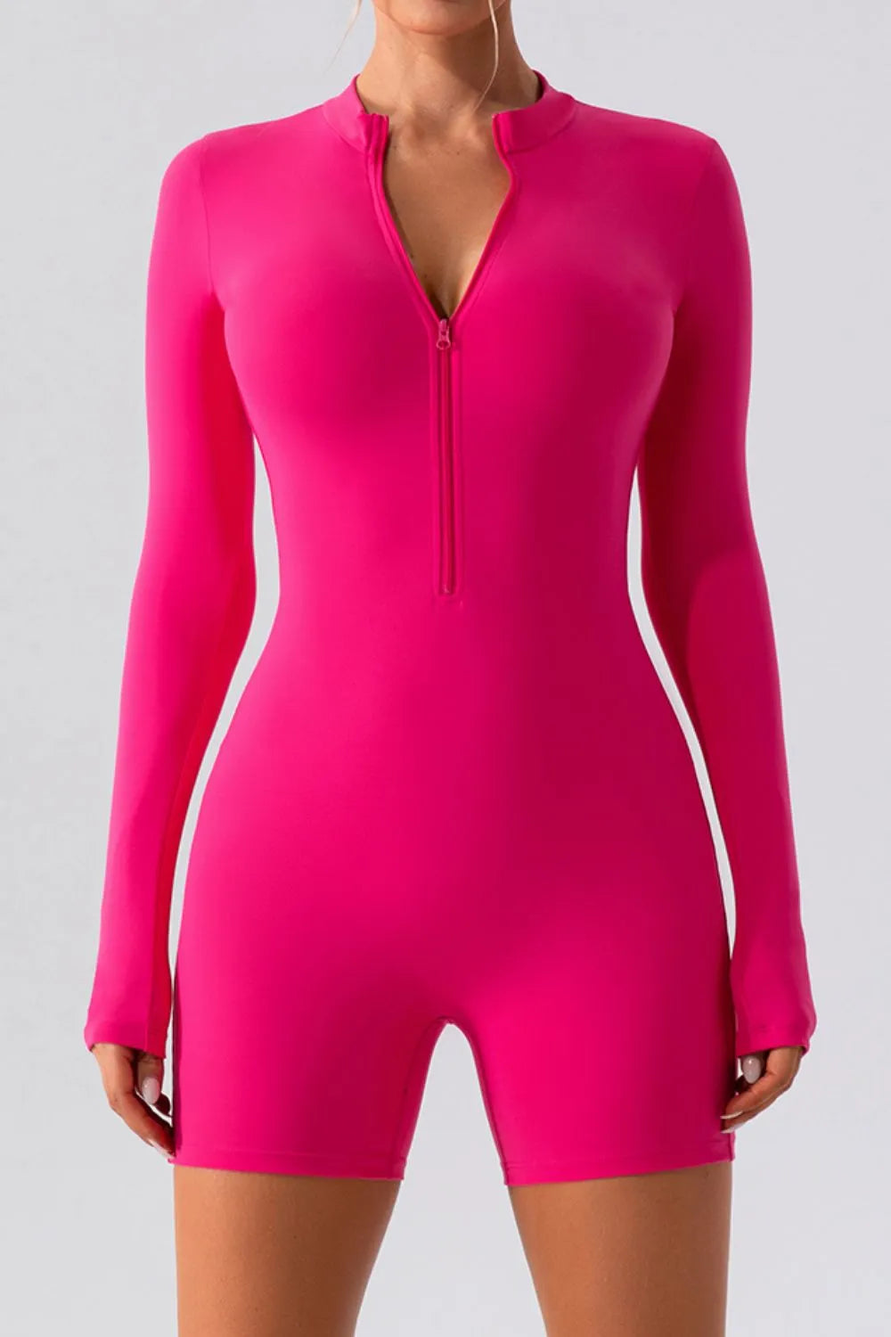 Hot pink half-zip long-sleeve active romper with front half zipper and shorts