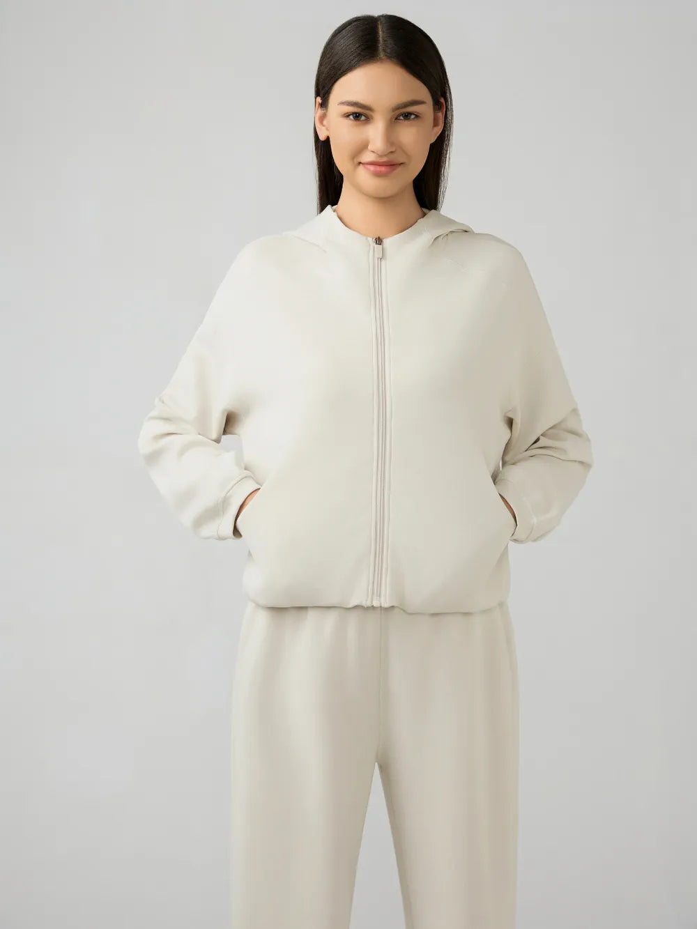 Cream zip-up hooded athletic jacket, dropped shoulders, front full view