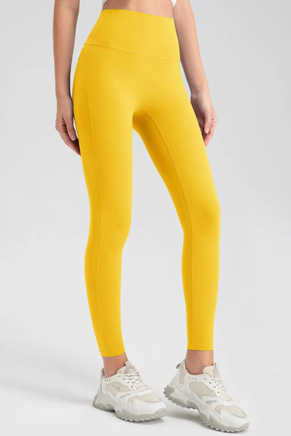 High-waist skinny active pants in mustard yellow, full-length, tapered leg