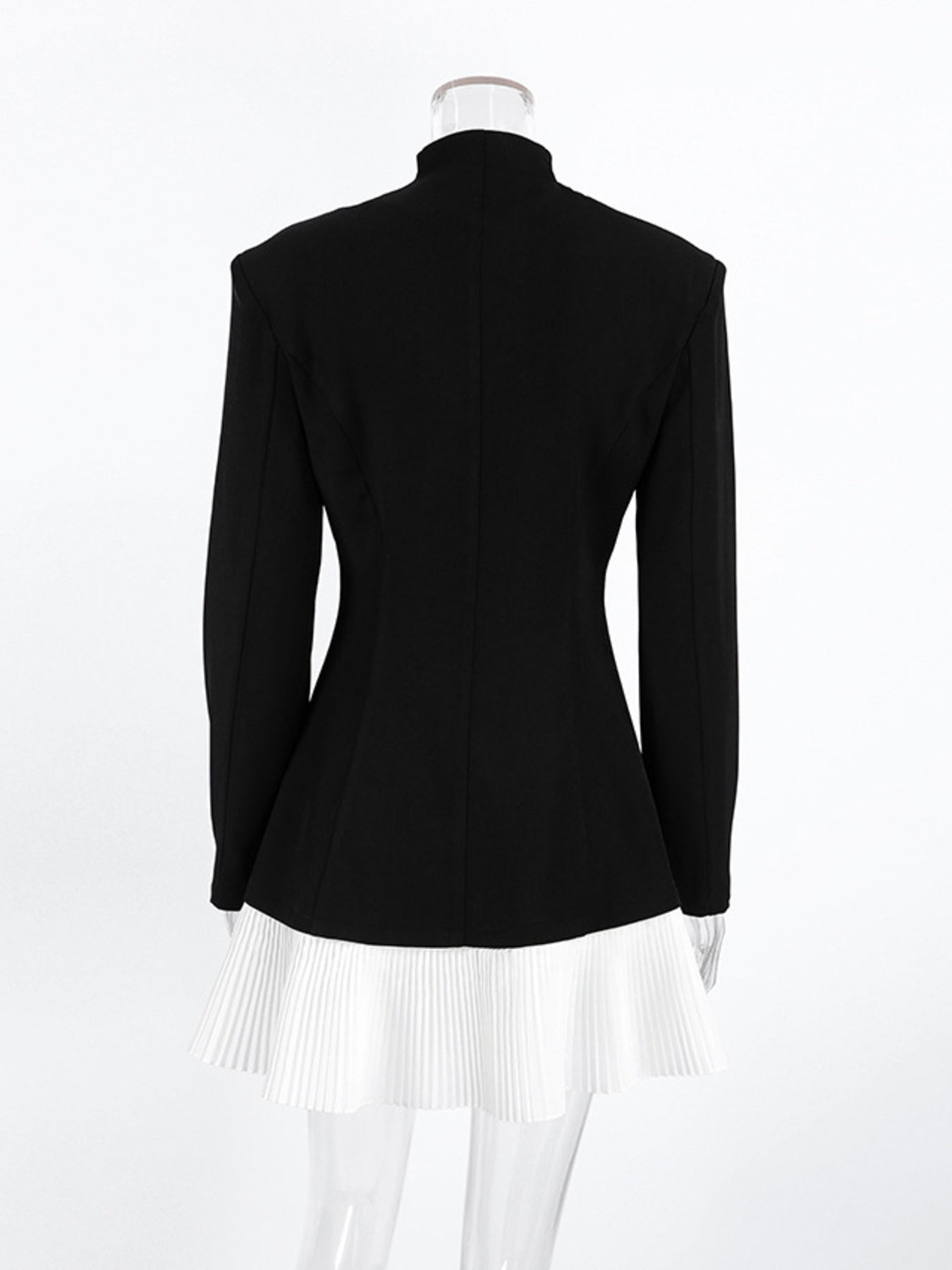 Black one-button blazer dress, back view, with long sleeves and pleated white hem