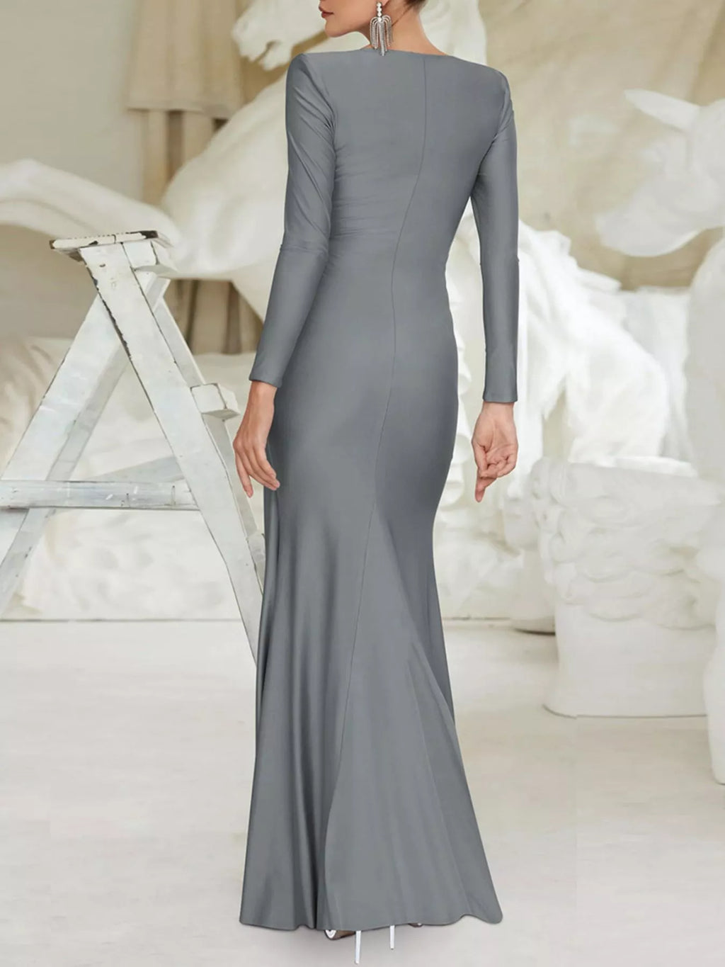 Gray twisted long-sleeve maxi dress with ruched back detail from shoulder to waist.