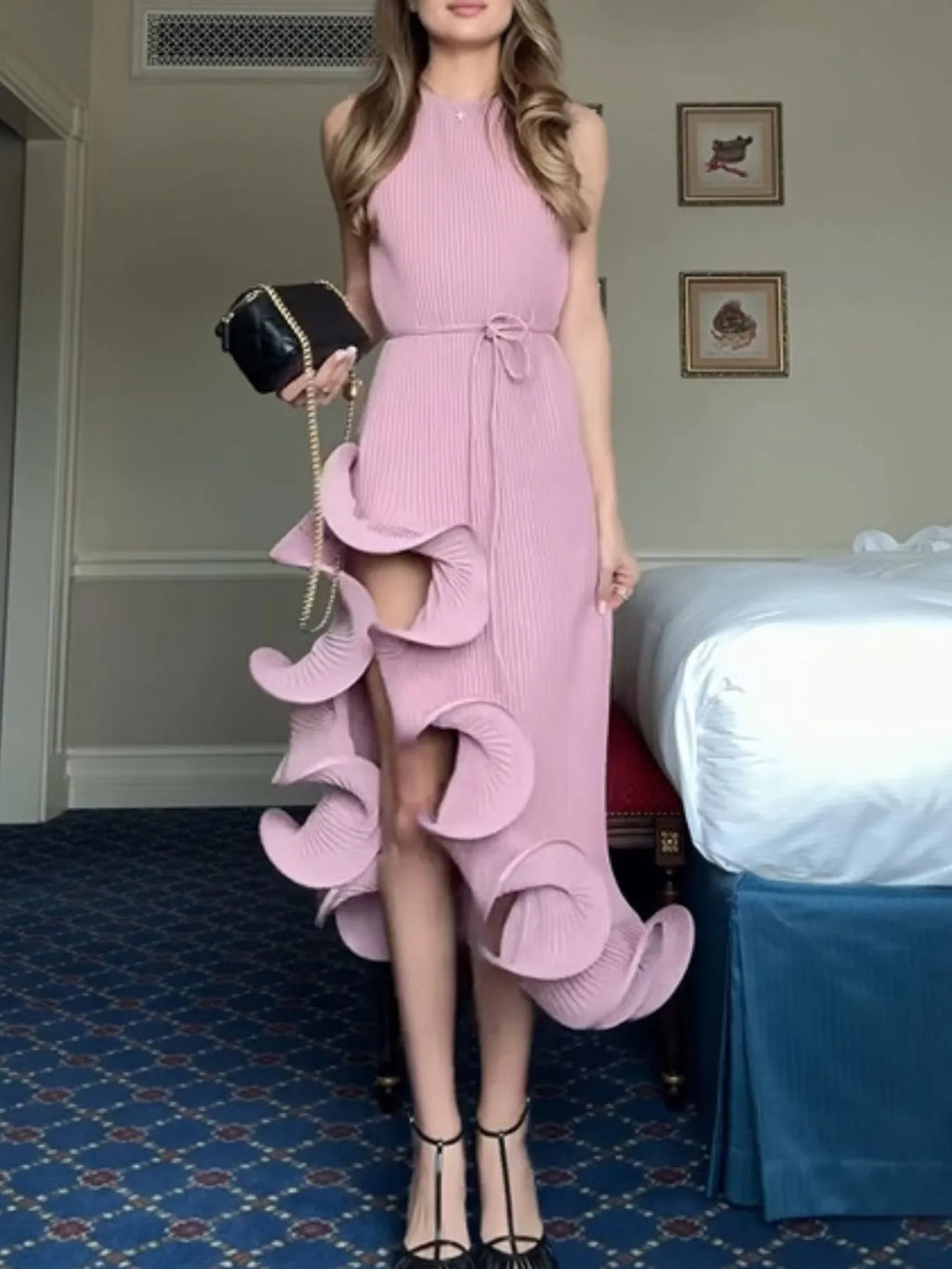 Pink ribbed sleeveless dress with ruffle hem and bow-tie waist, tiered flutter design