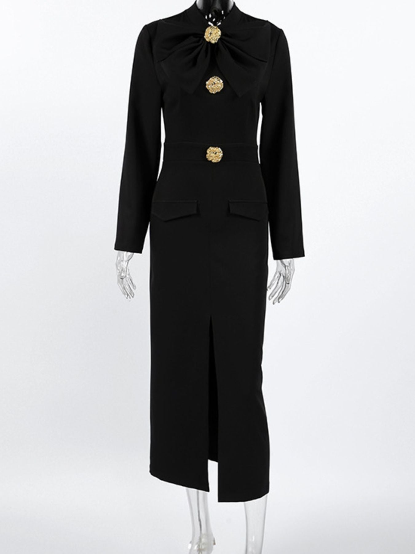 Black long-sleeve midi dress on mannequin with ruched bodice, gold buttons, and slit.