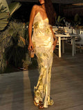 Gold backless V-neck maxi dress with thin spaghetti straps, shimmering gold print