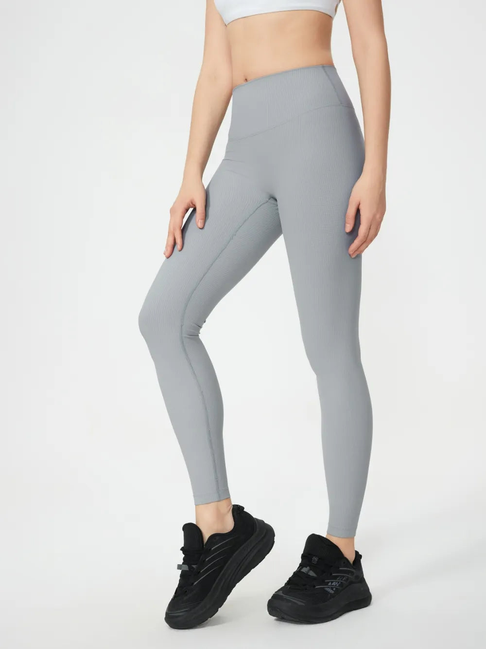 Light gray high-waist active leggings, full-length fitted with seam detailing.