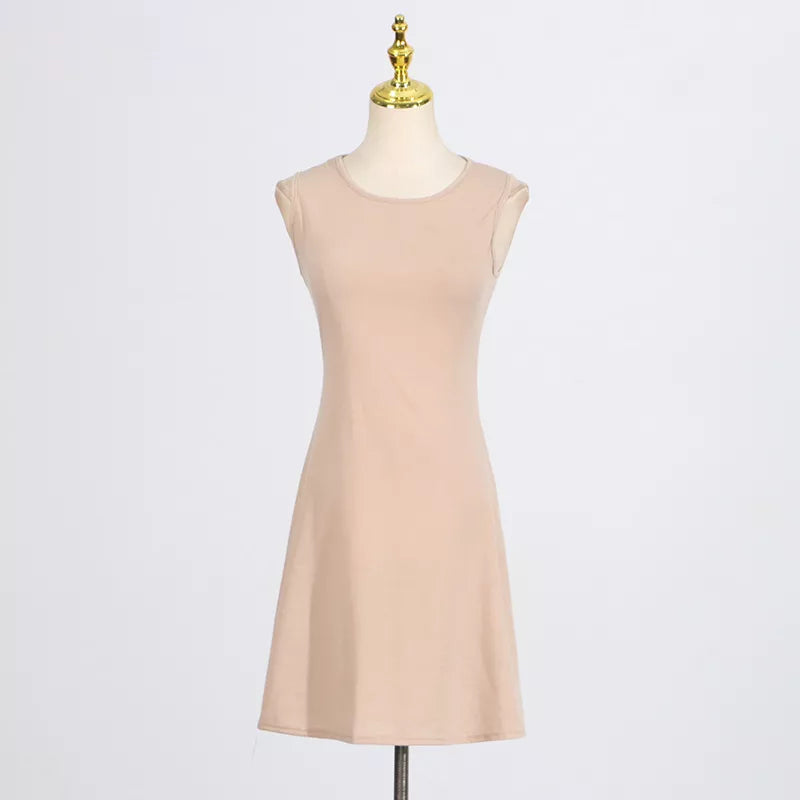 Beige sleeveless shift dress on mannequin, smooth fabric and crew neckline