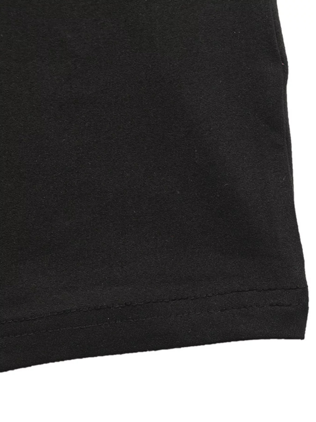 Black midi dress hem with visible stitching along the bottom edge