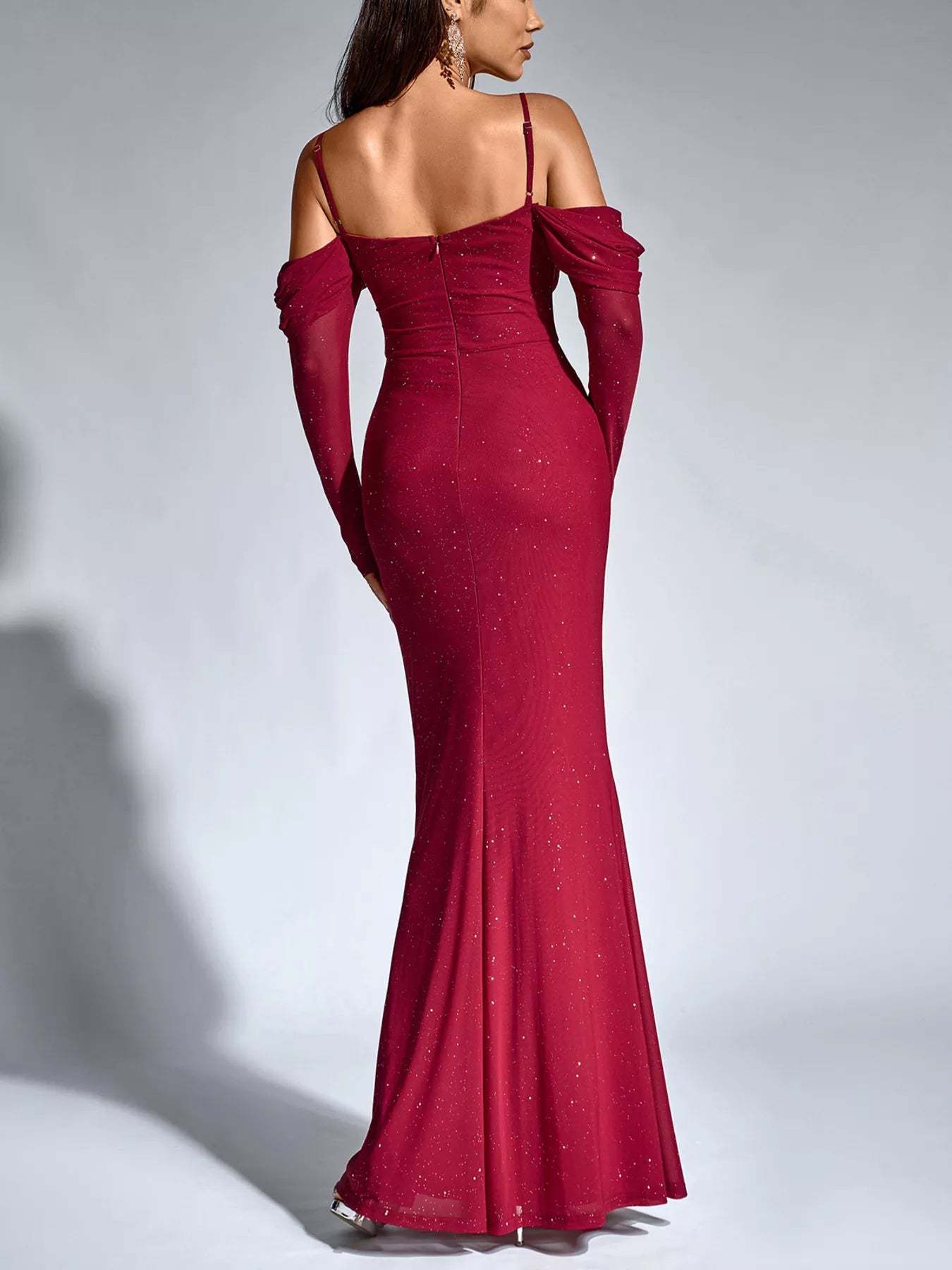 Wine red glitter mermaid maxi dress from side view with off-shoulder long sleeves and ruched fit