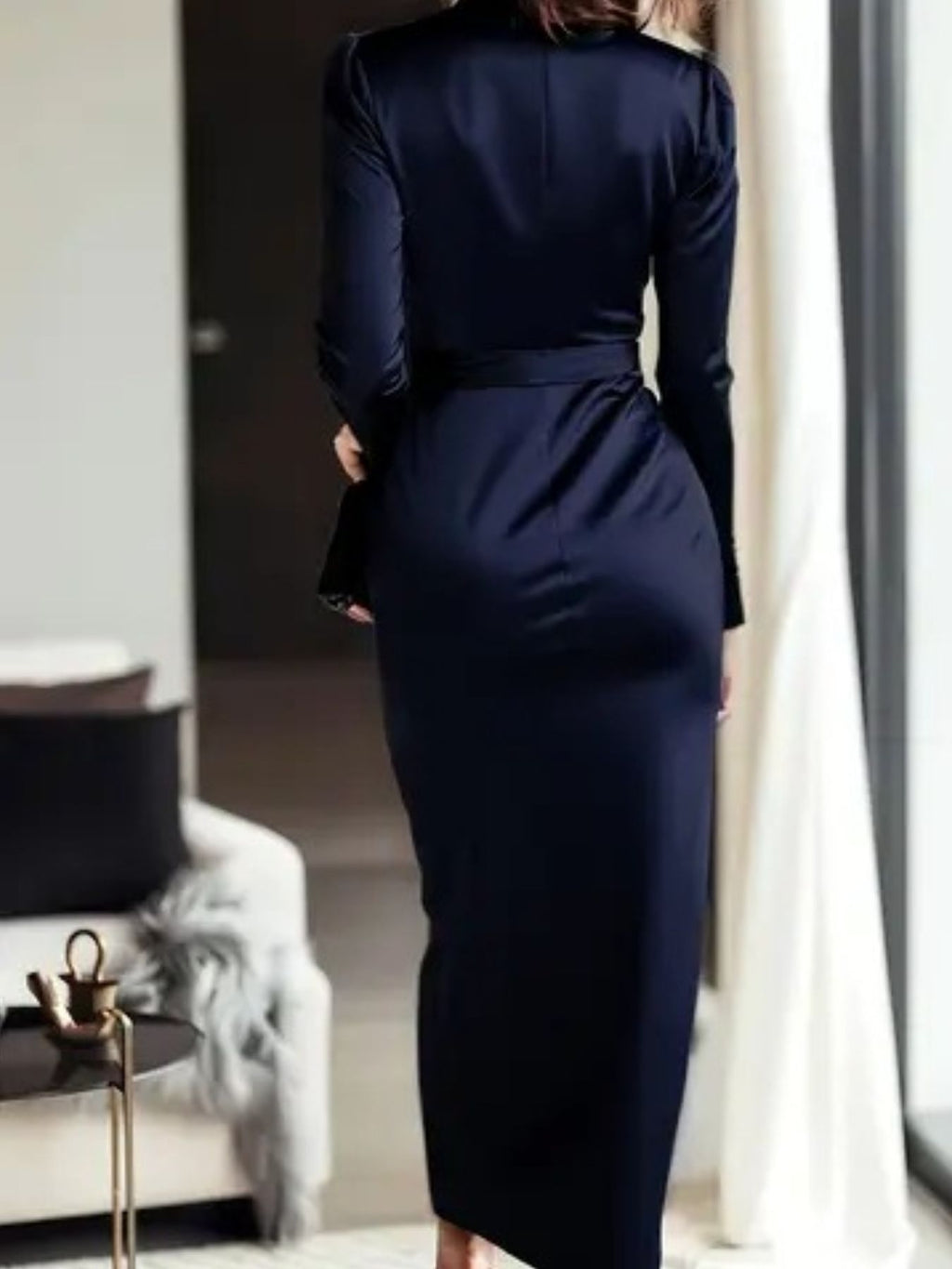 Dark blue satin long-sleeve wrap dress, back view with cinched tie waist