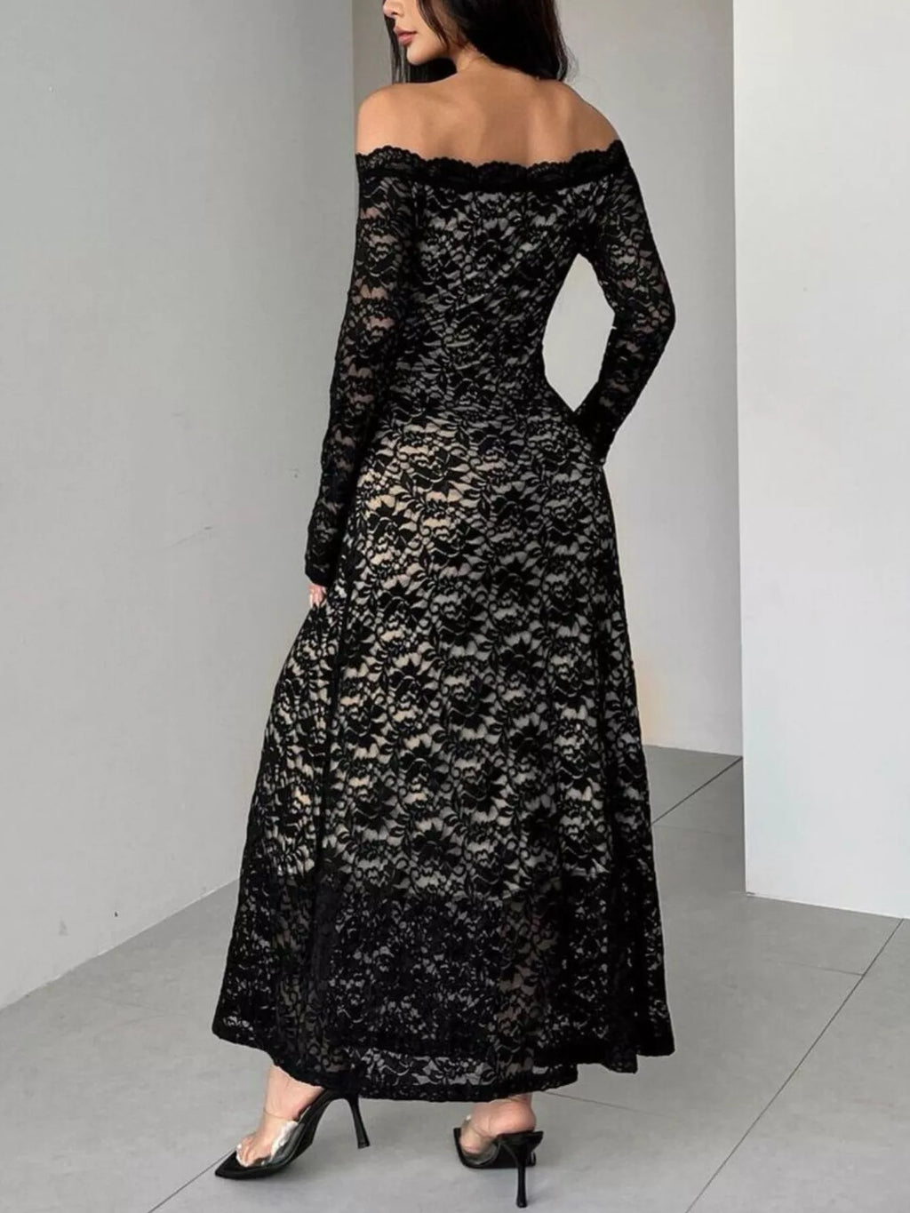 Black off-shoulder lace maxi dress with long sleeves, side view, full skirt
