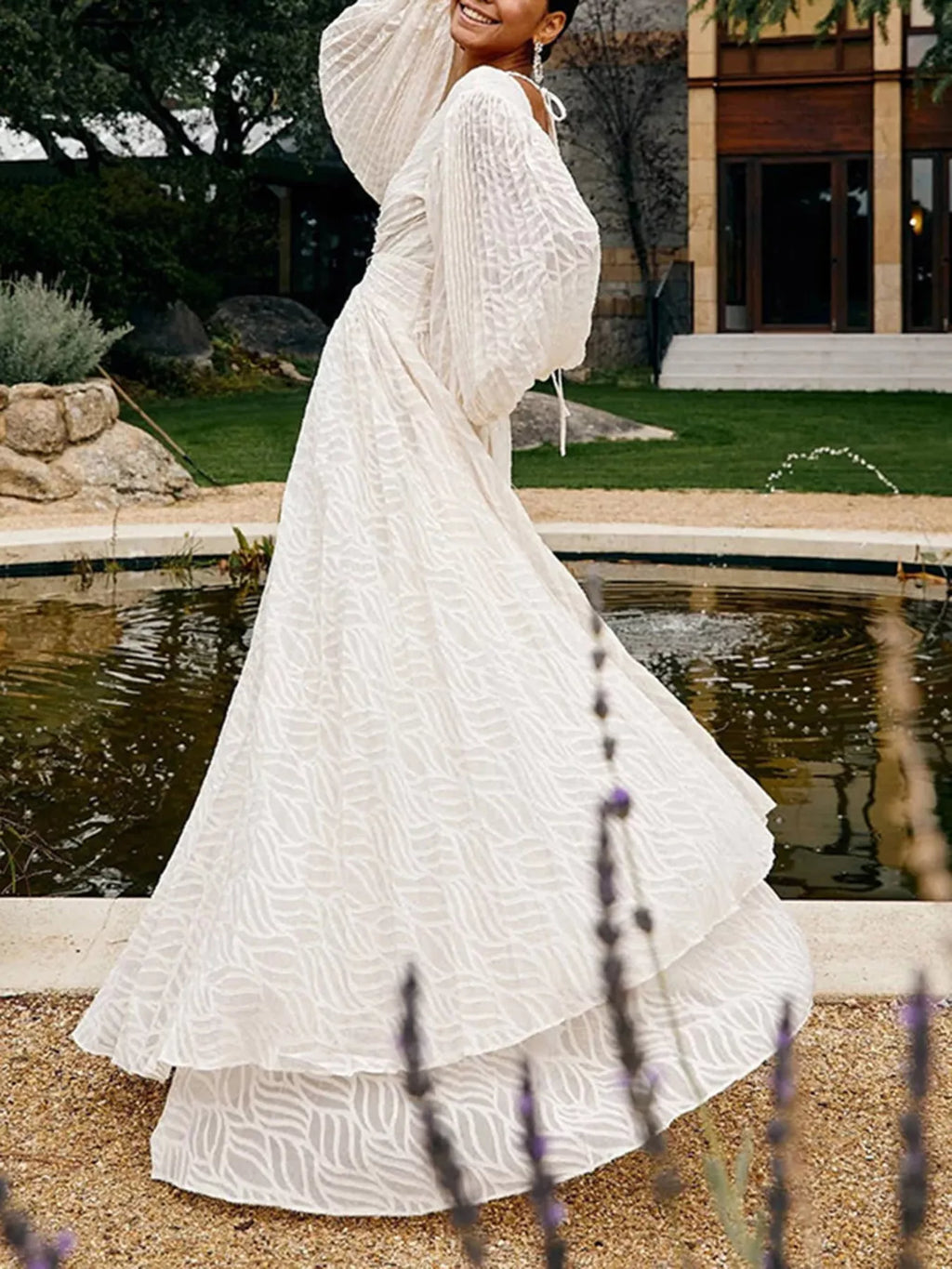 White textured v-neck maxi dress with long puff sleeves and flowing skirt
