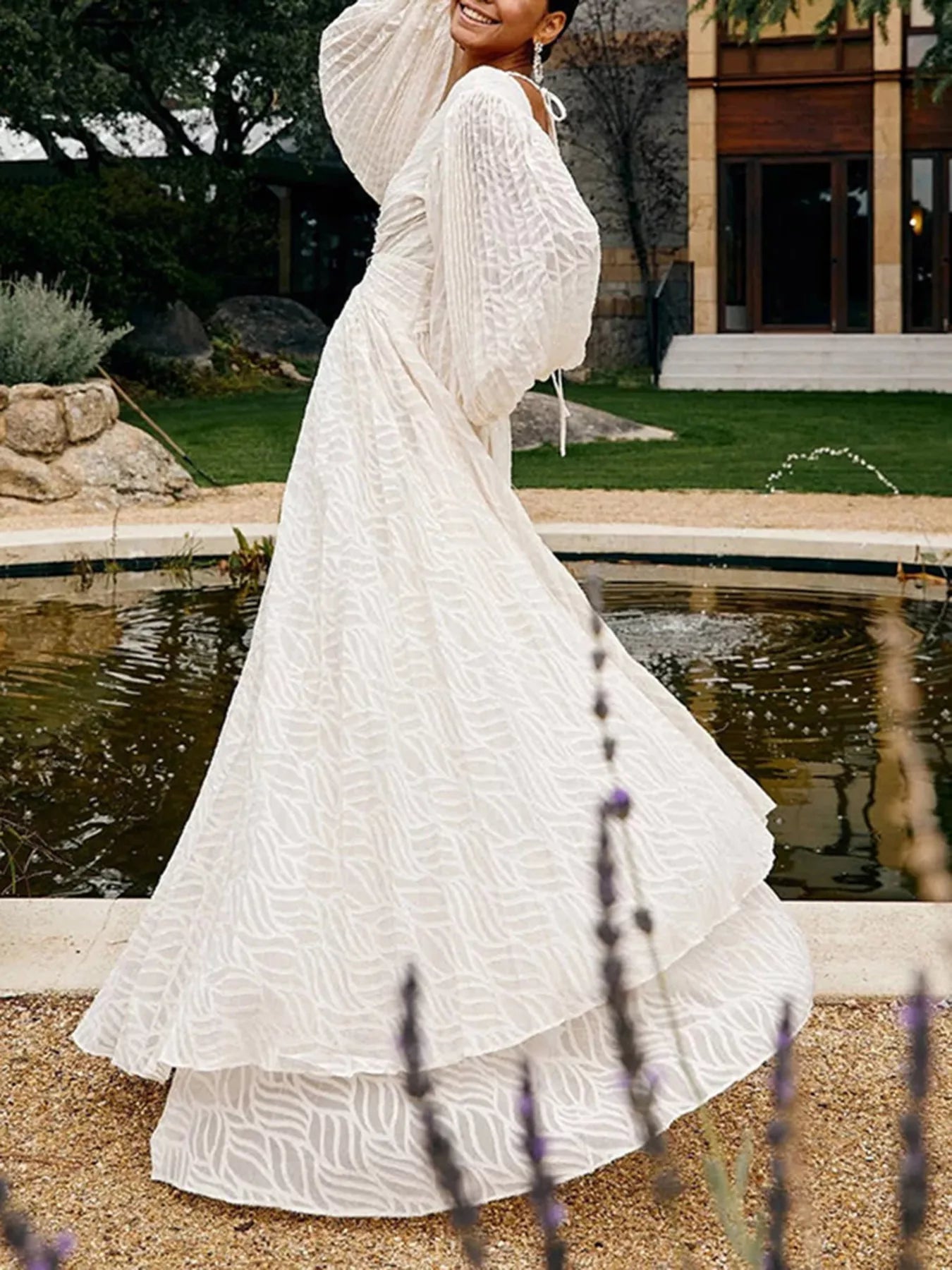 White textured v-neck maxi dress with long puff sleeves and flowing skirt