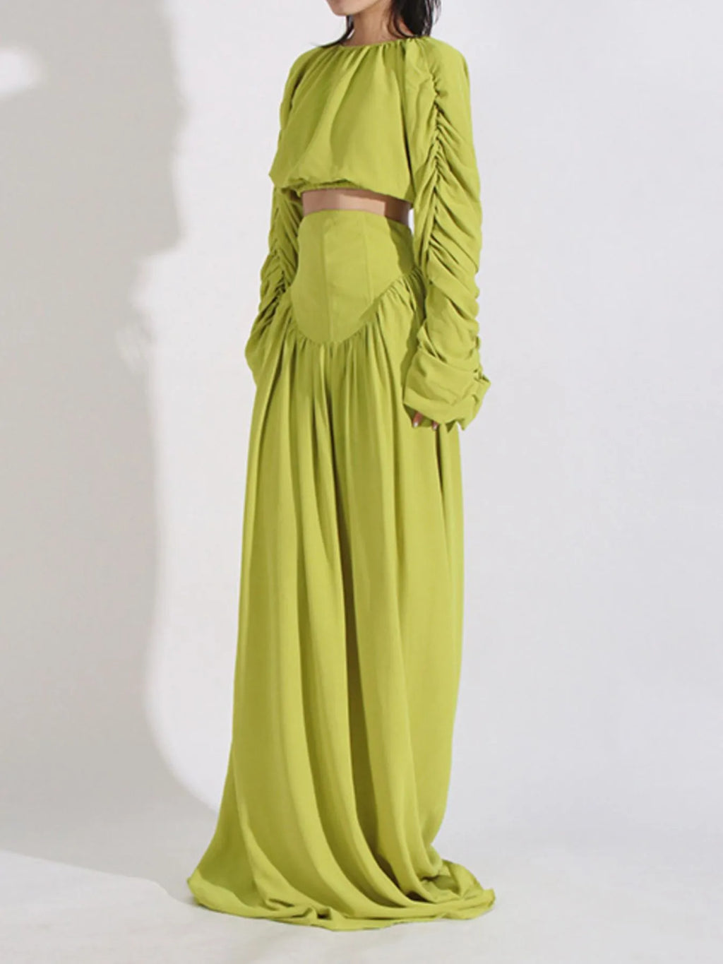 Green ruched long-sleeve crop top and high-waist maxi skirt, side view
