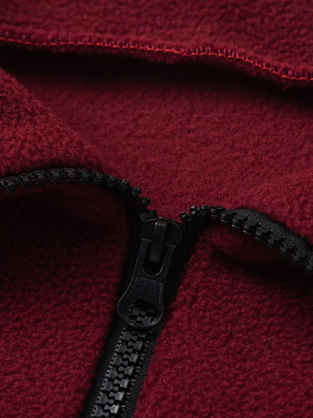 Burgundy quarter-zip sweatshirt close-up of zipper and collar
