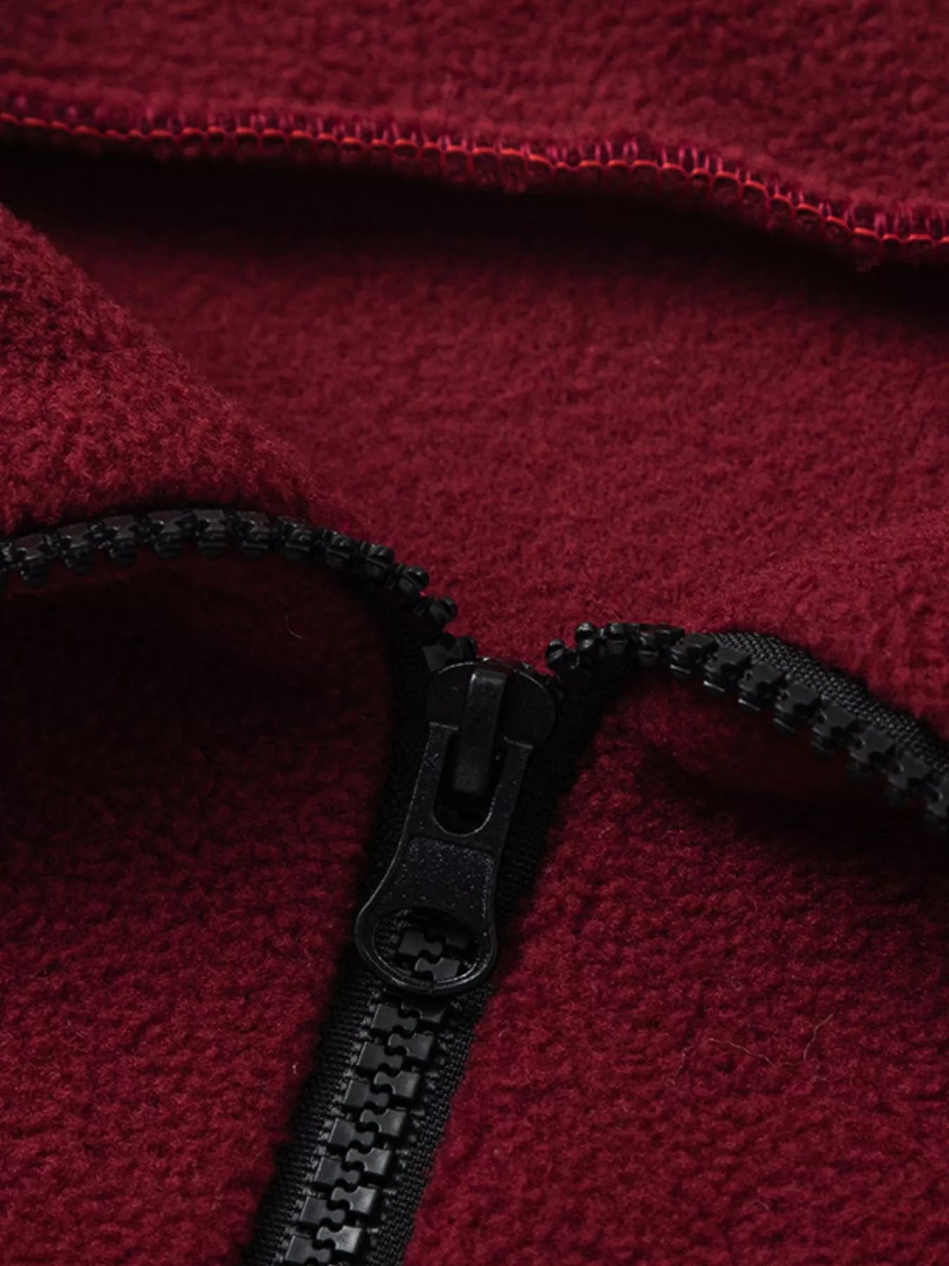Burgundy quarter-zip sweatshirt close-up of zipper and collar