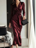 Burgundy satin long-sleeve wrap dress with V-neck and tie waist, midi length