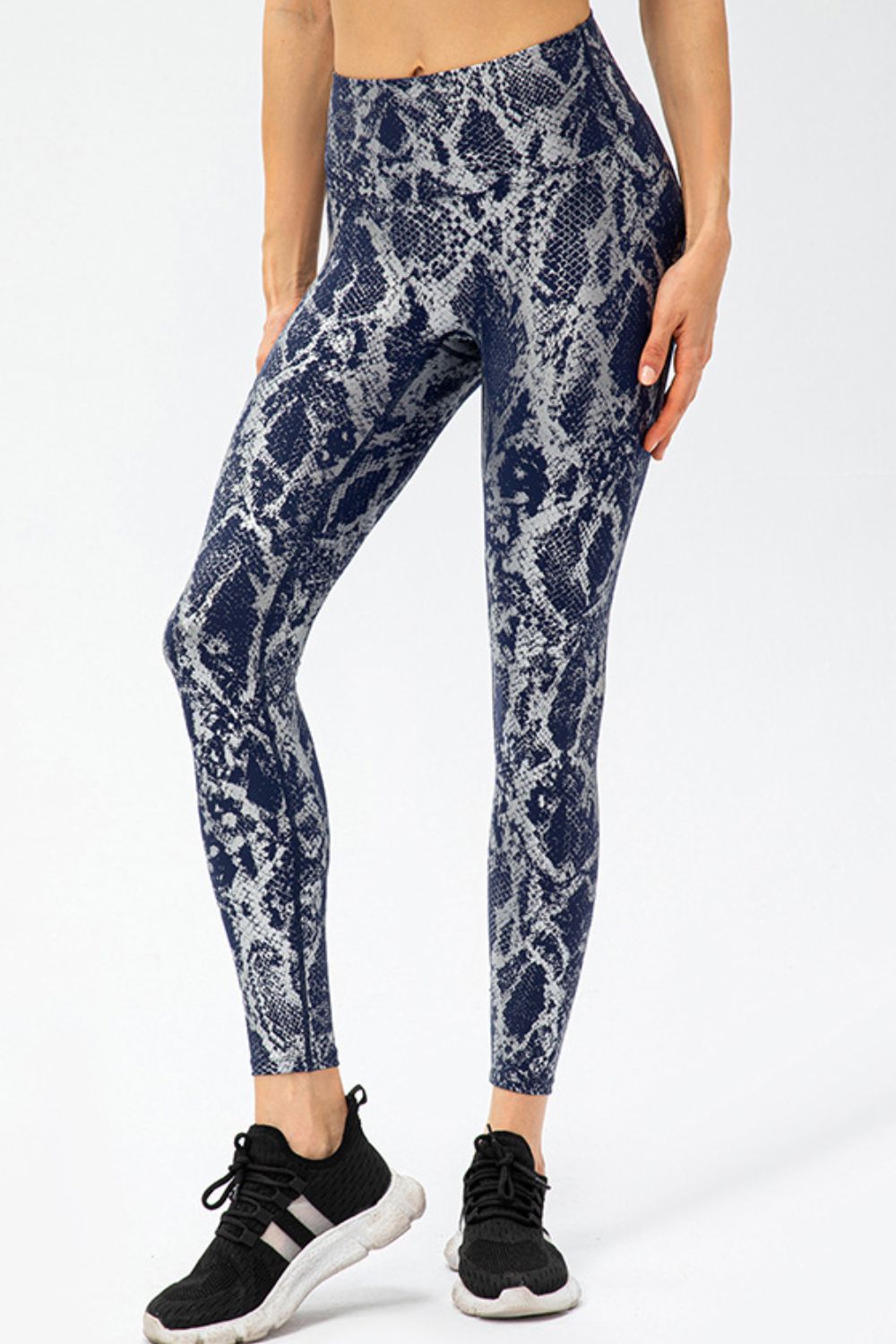 Animal-print slim-fit long sports pants with wide waistband, dark blue snake pattern.