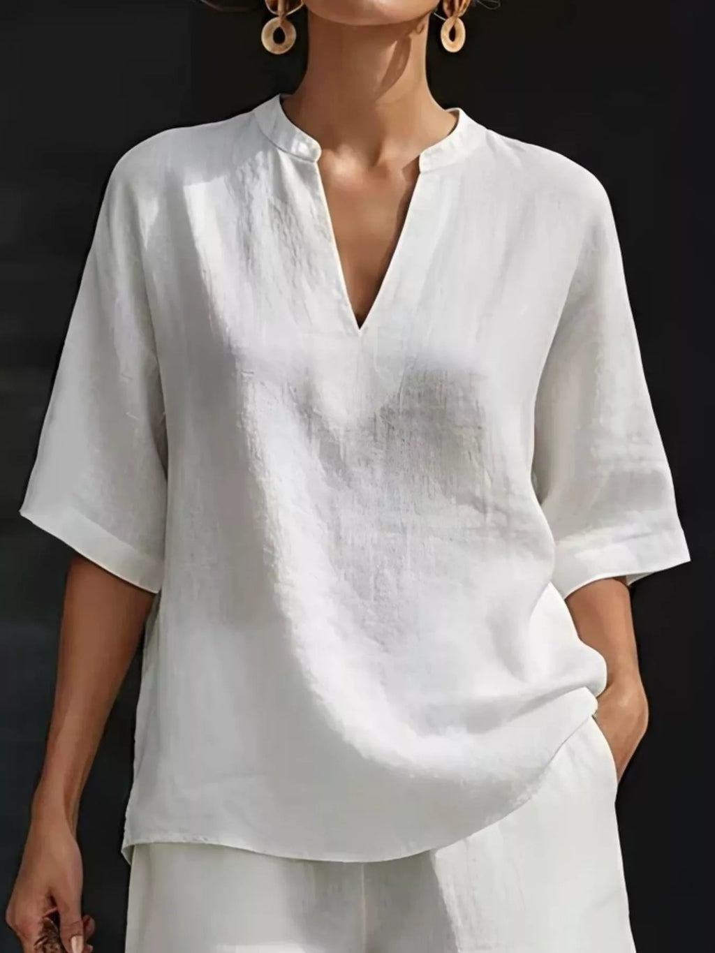 White half-sleeve V-neck top with notched neckline and matching shorts