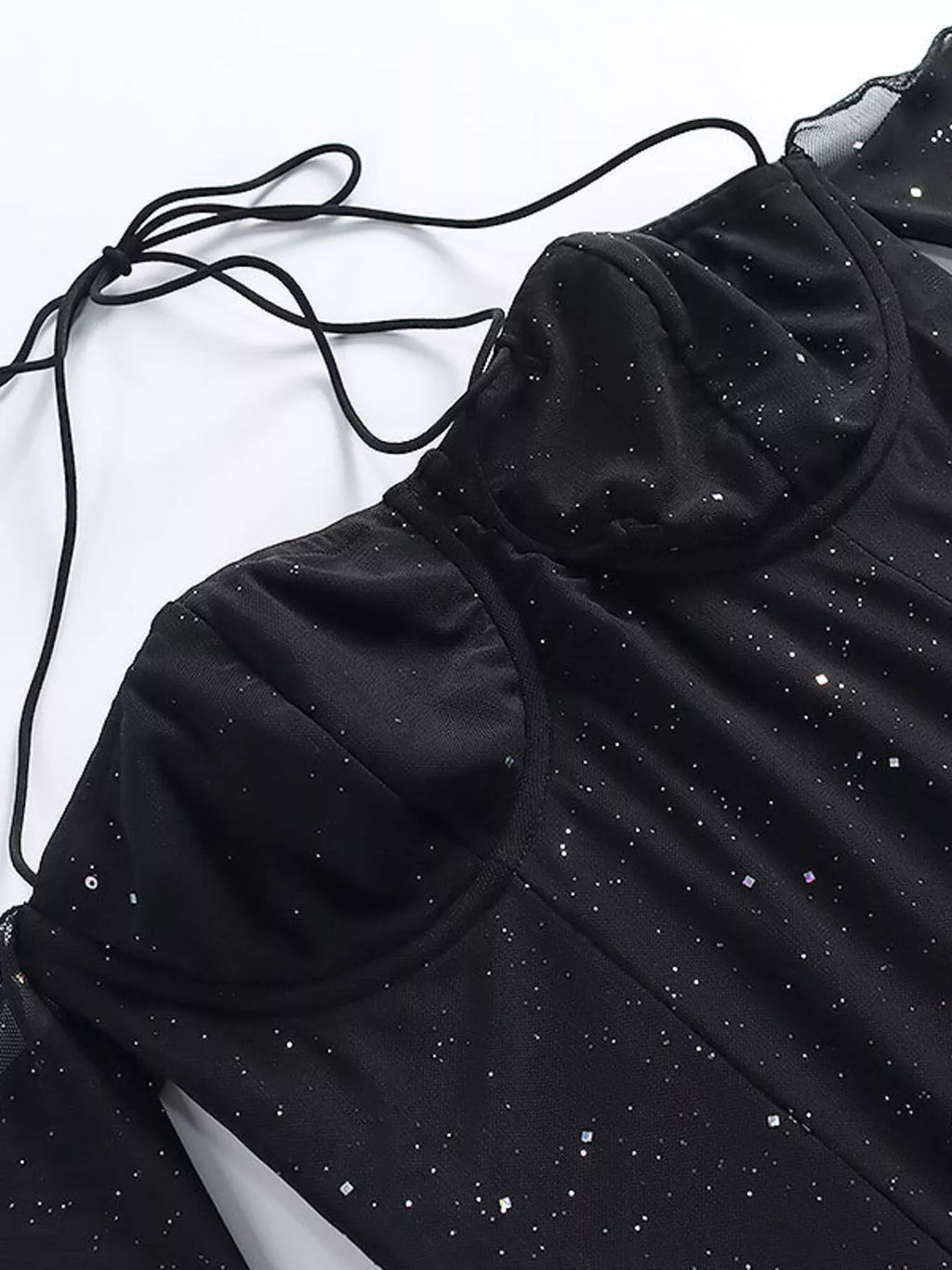 Black glitter mini dress detail: sweetheart cups, thin straps, and dotted sparkle pattern