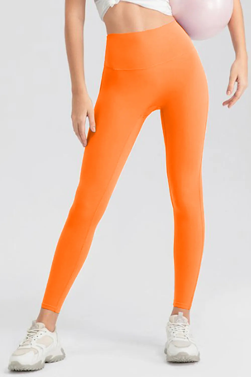 Orange high-waist skinny active pants, front view, slim tapered legs