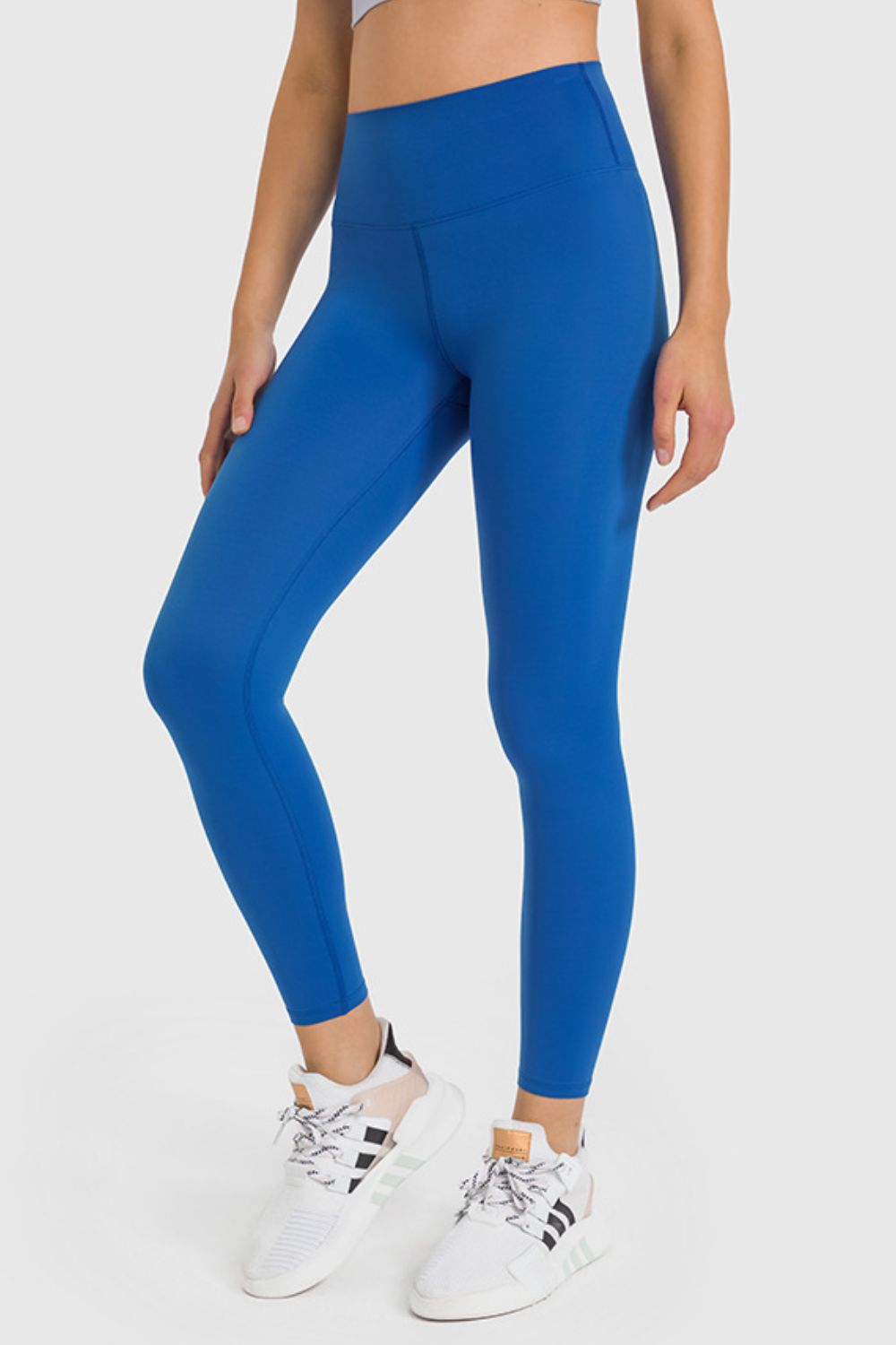 High-waist ankle-length yoga leggings in peacock blue, front leg view