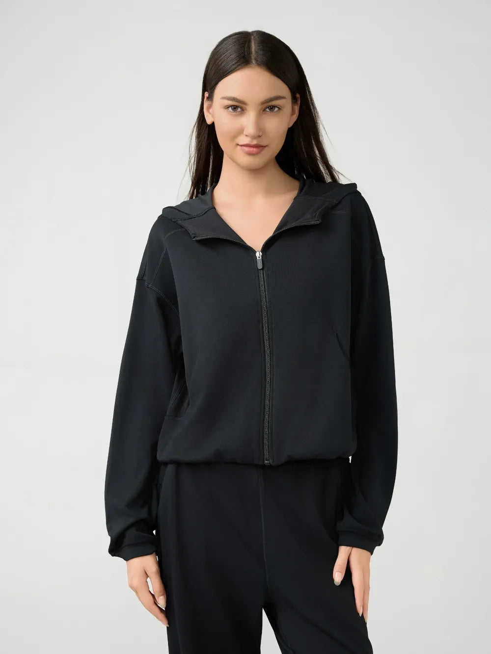 Black zip-up active hoodie with hood and front zipper, relaxed dropped-shoulder fit
