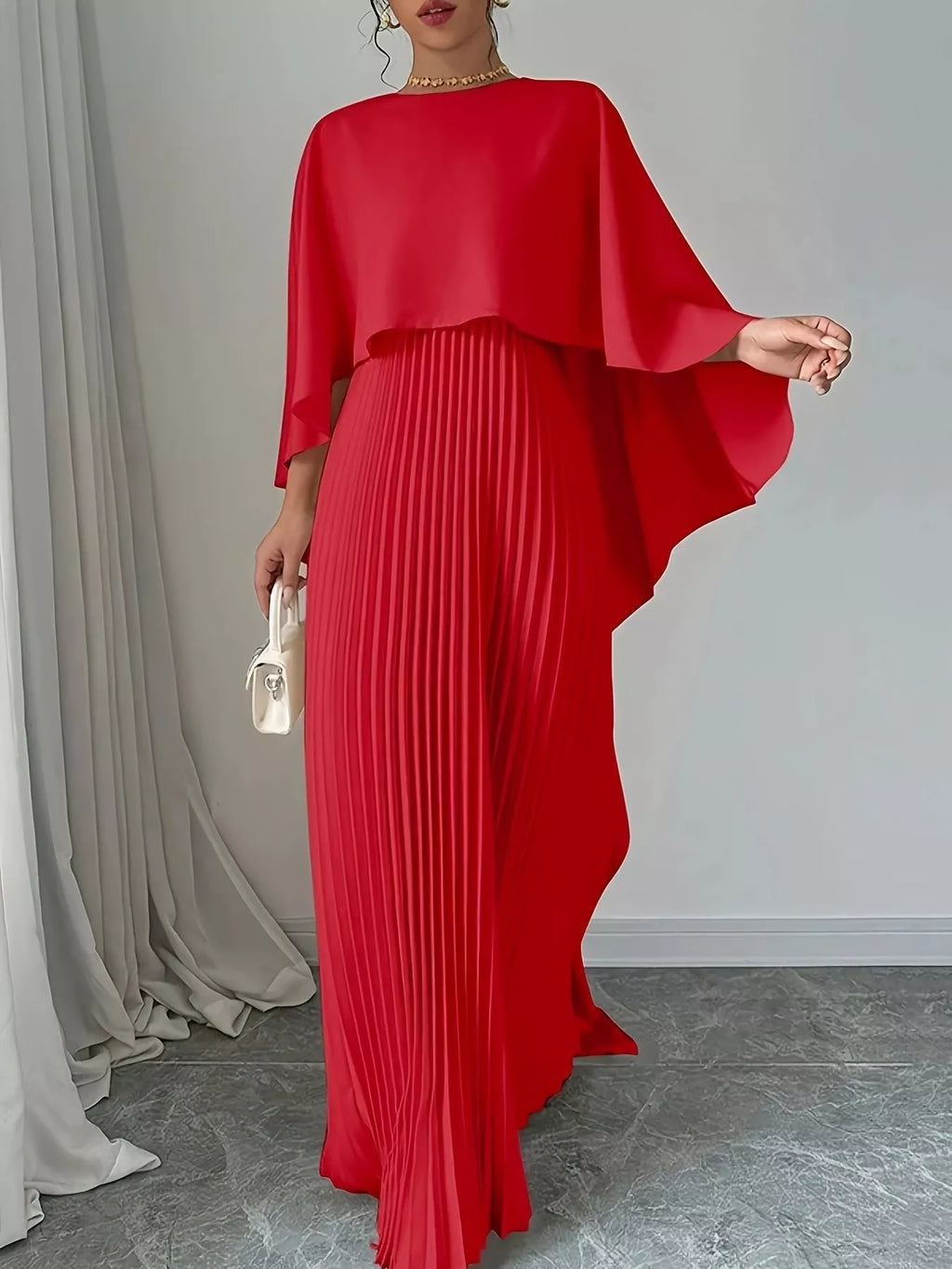 Red cape pleated maxi dress with flowing cape sleeves and pleated skirt
