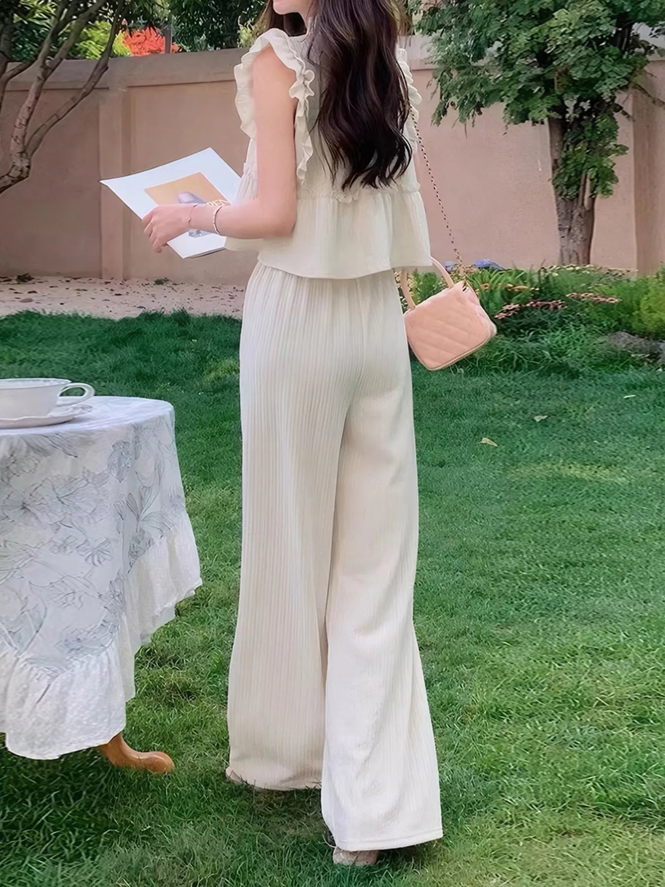 Apricot sleeveless ruffled top with lace-trim shoulder and wide-leg pants