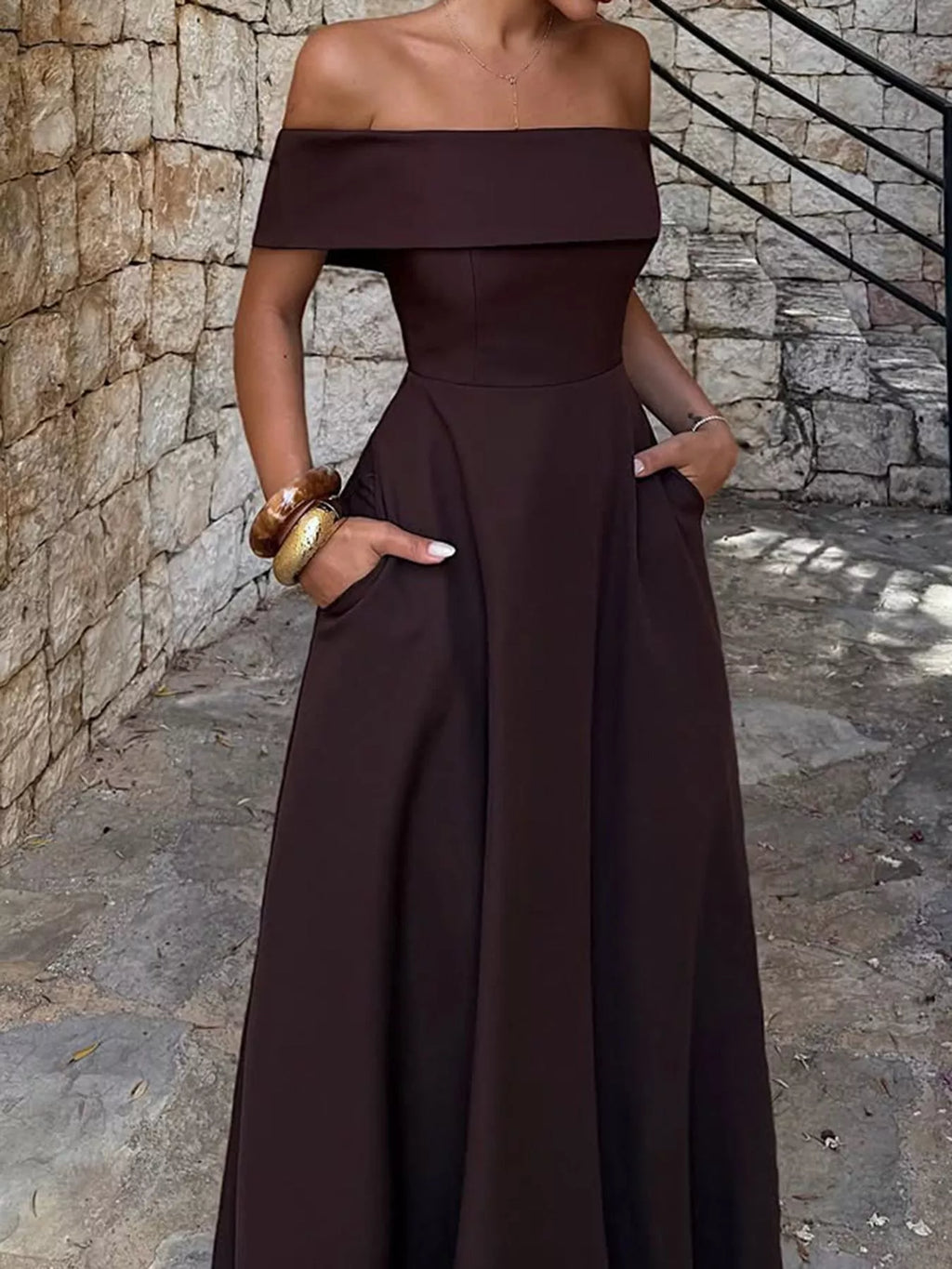 Off-shoulder A-line maxi dress in dark burgundy with structured waist and flowing skirt