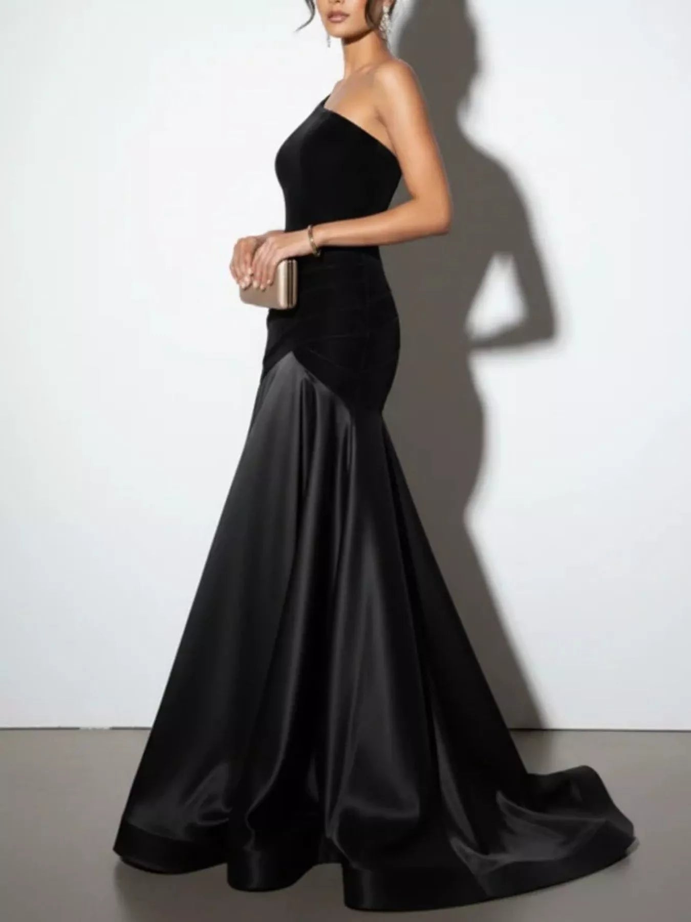 Black one-shoulder floor-length dress with fitted bodice and soft pleated satin skirt