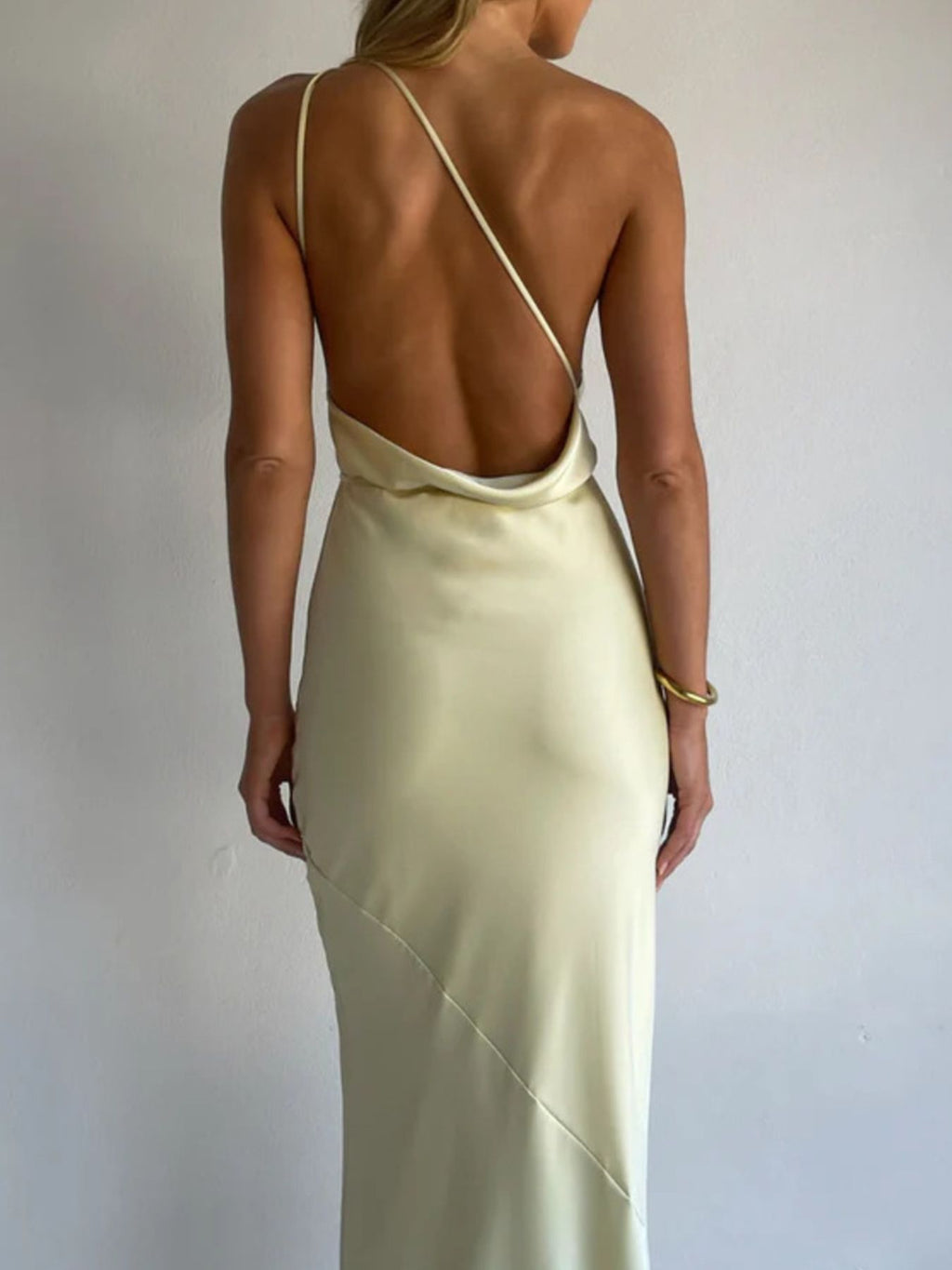 Light yellow satin backless halter maxi dress with center seam and thin straps