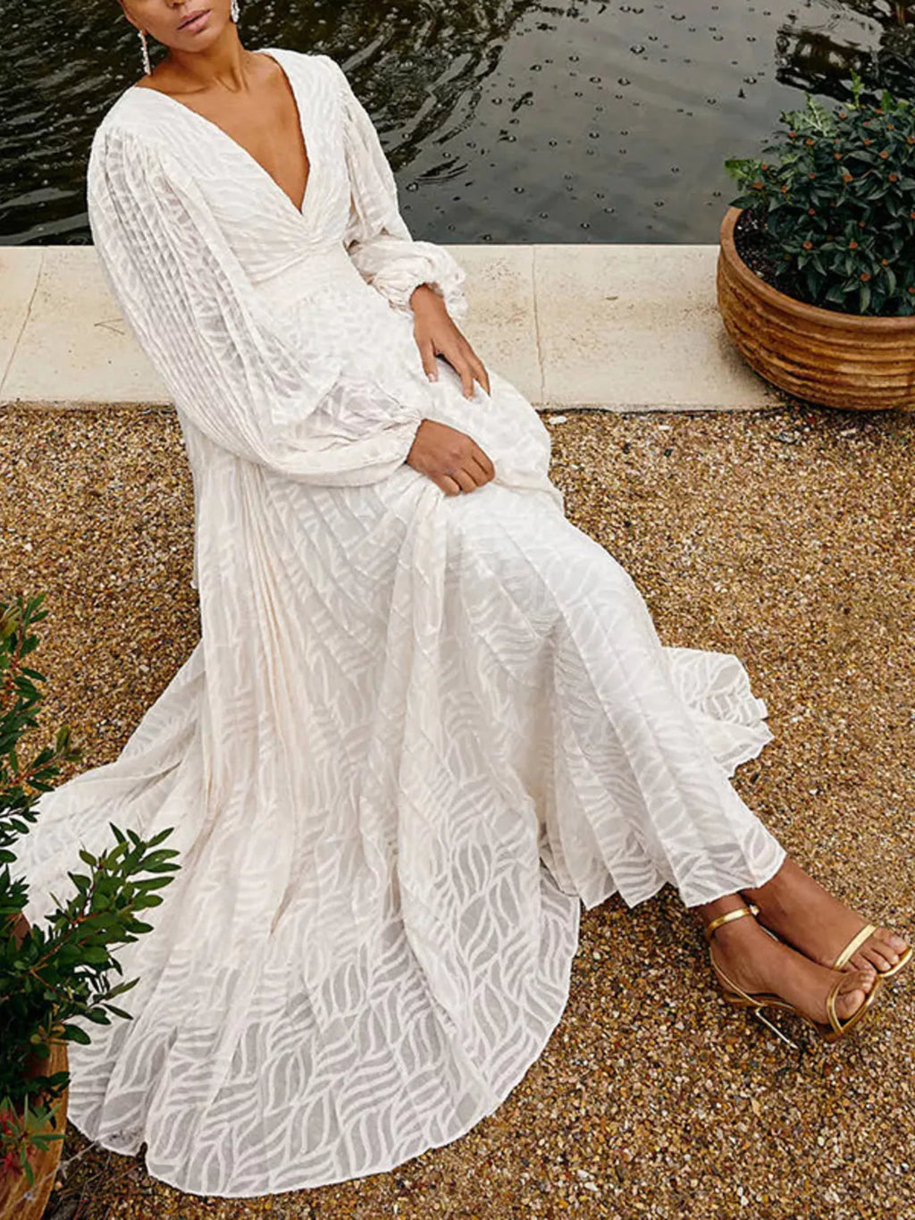 White v-neck long-sleeve maxi dress with elastic cuffs and full ruffled skirt