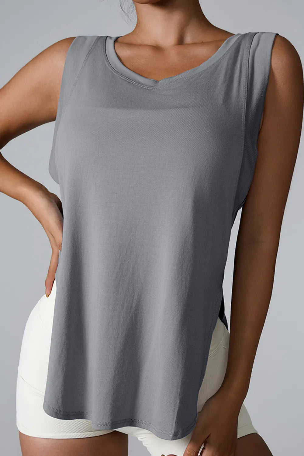Gray sleeveless active tank with round neck and side slit, breathable athletic fit.