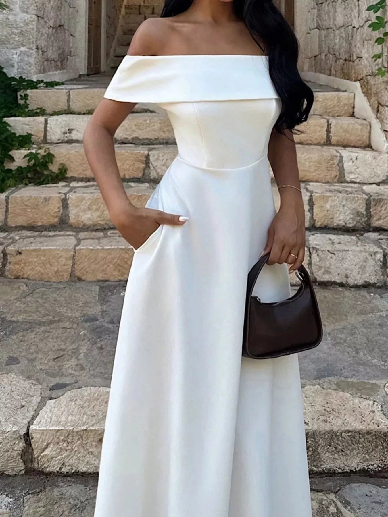 Off-shoulder A-line maxi dress in off-white with fitted waist and flowing flared skirt