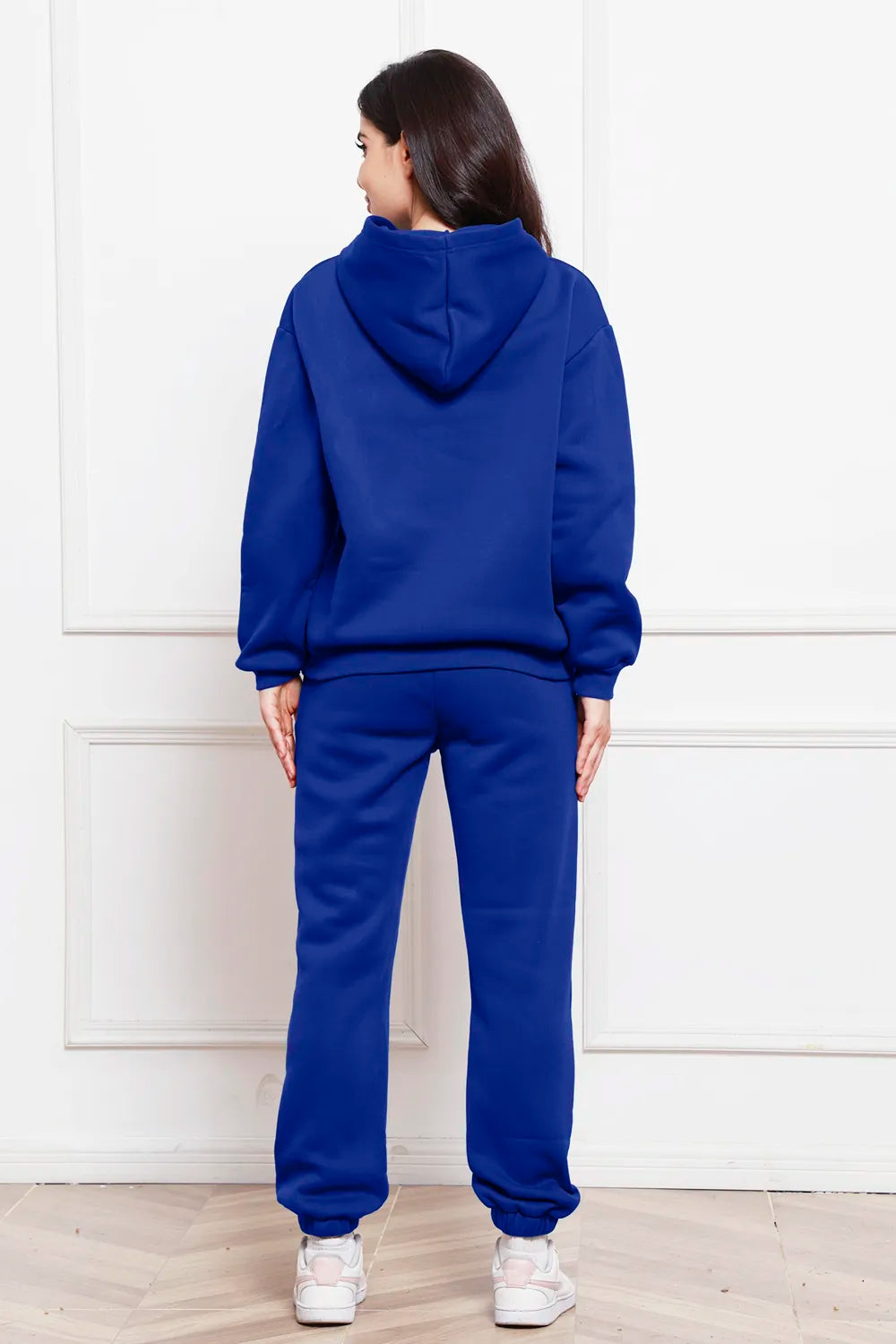 Hoodie and pants set in dark blue, back view with drawstring hood and cuffed joggers